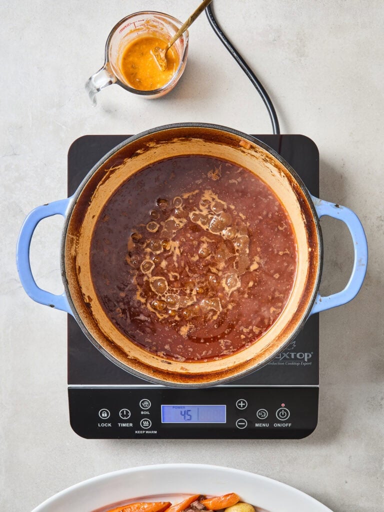 Cooking down pot roast liquid to form a gravy.