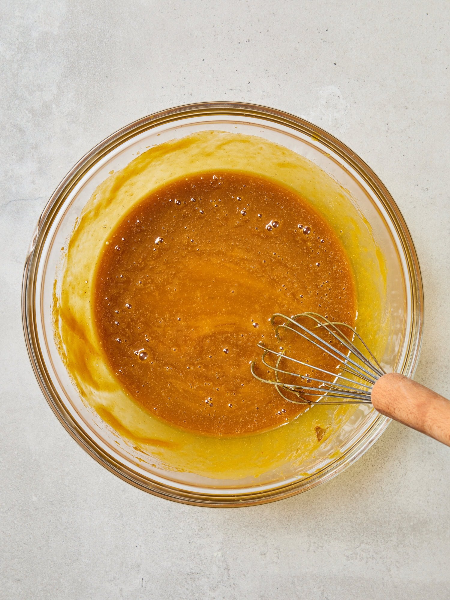 Wet ingredients mixed in a bowl for pumpkin muffins.
