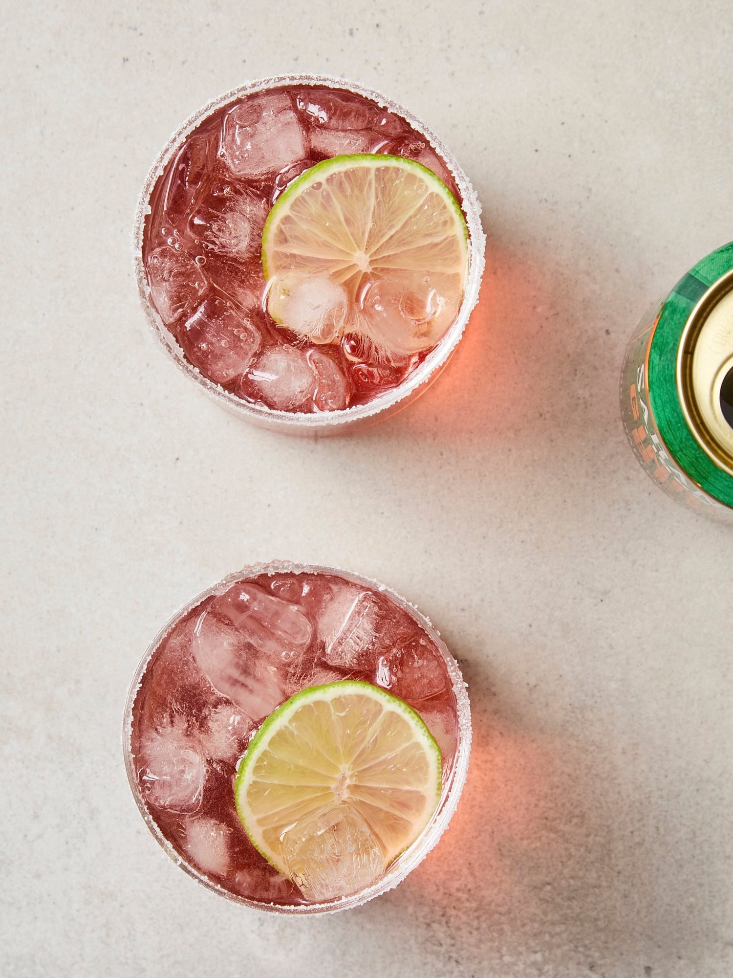 Two glasses made with margarita with lime wedge and topped with ginger beer.
