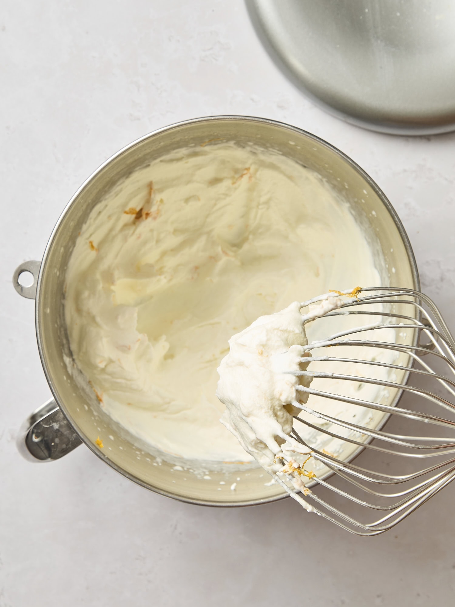 Mixing bowl filled with orange whipped cream.