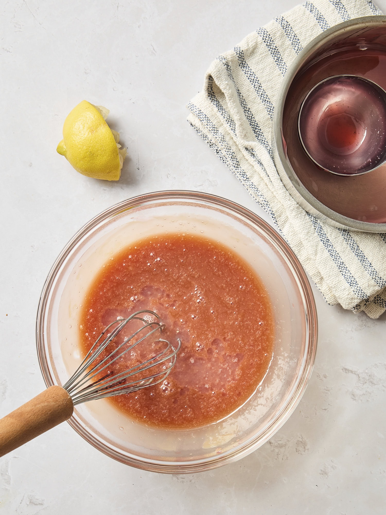 Glass bowl with cranberry tart filling with lemon juice added in.