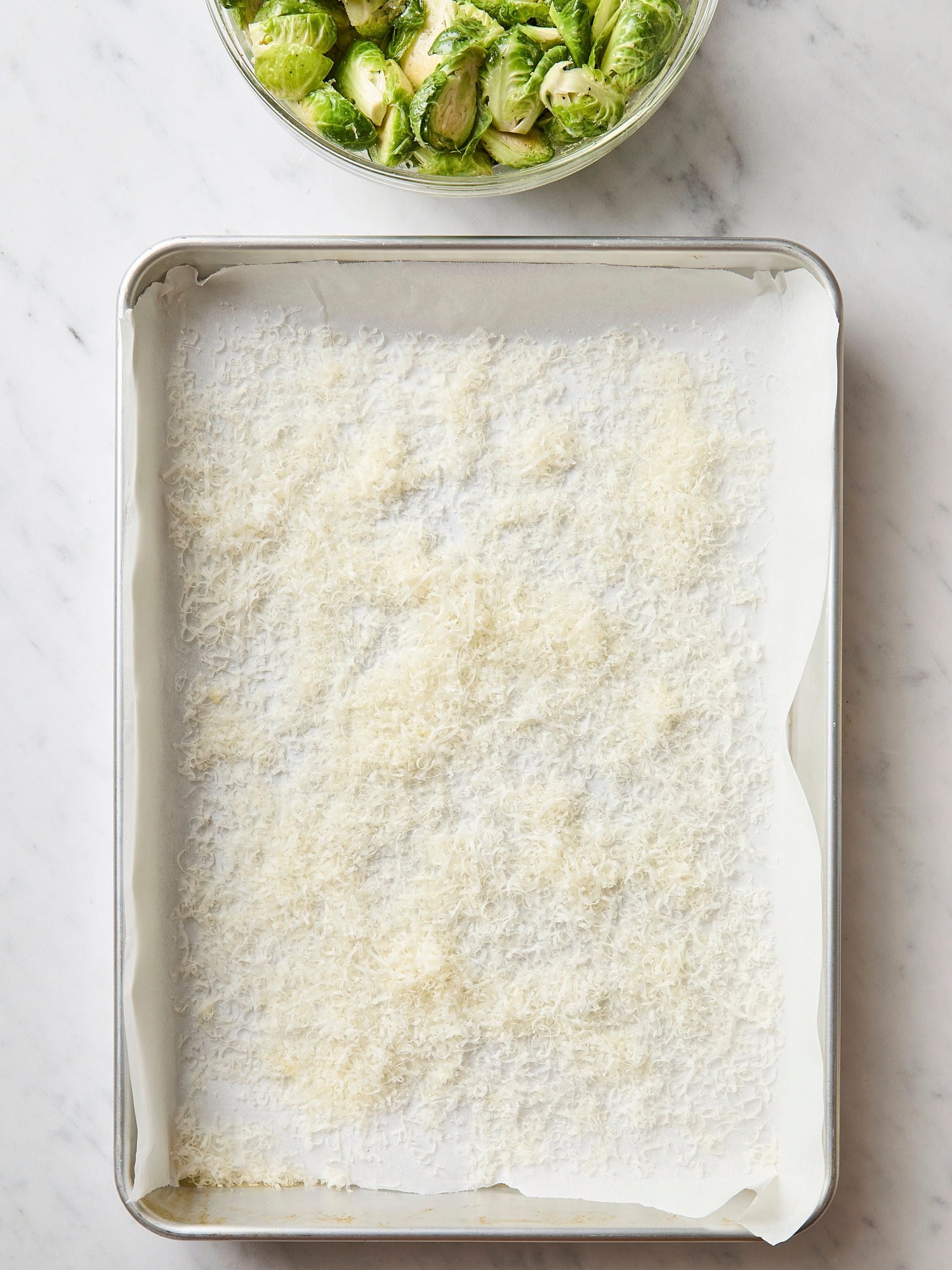 Sheet pan with Parmesan cheese all over.
