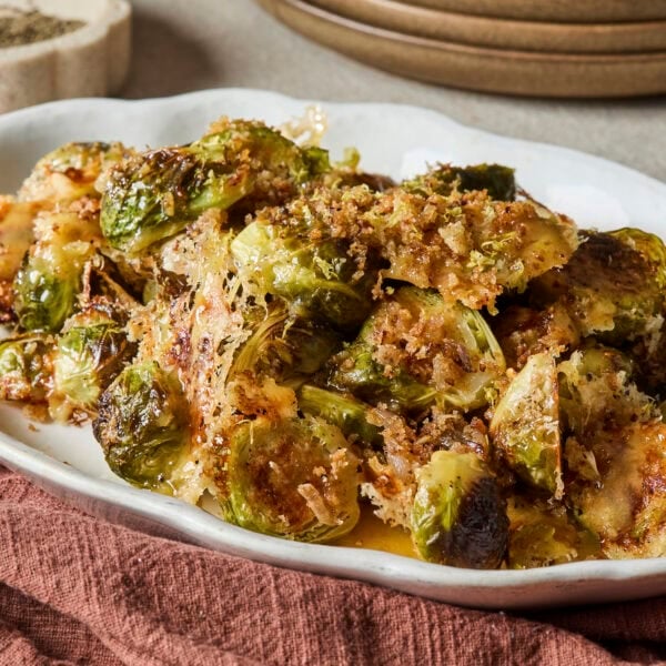 White platter with roasted Brussels sprouts side dish for Thanksgiving.