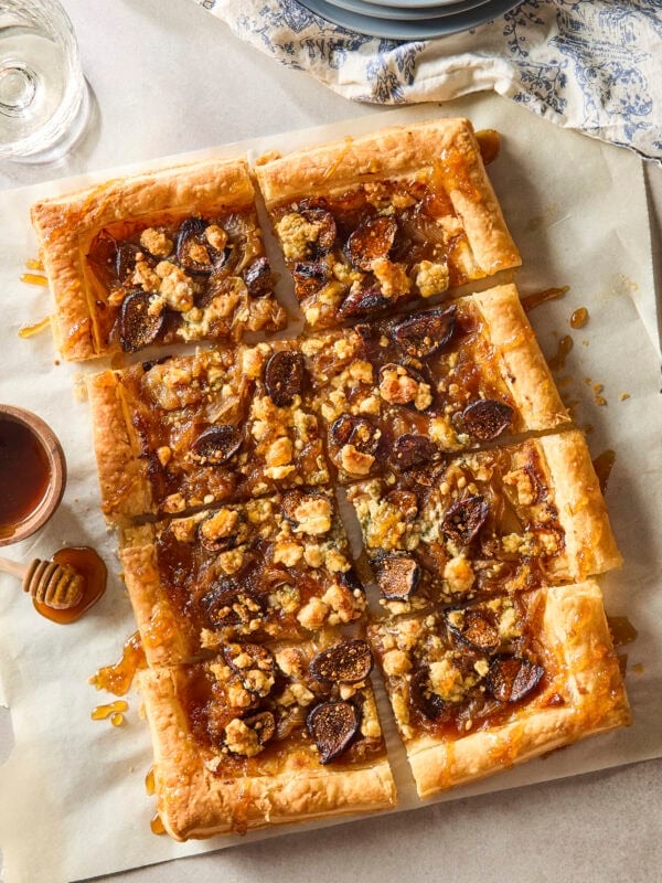 Caramelized onion tart with golden crispy crust drizzled with honey.