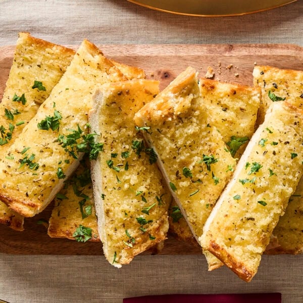Garlic bread topped with freshly chopped parsley.