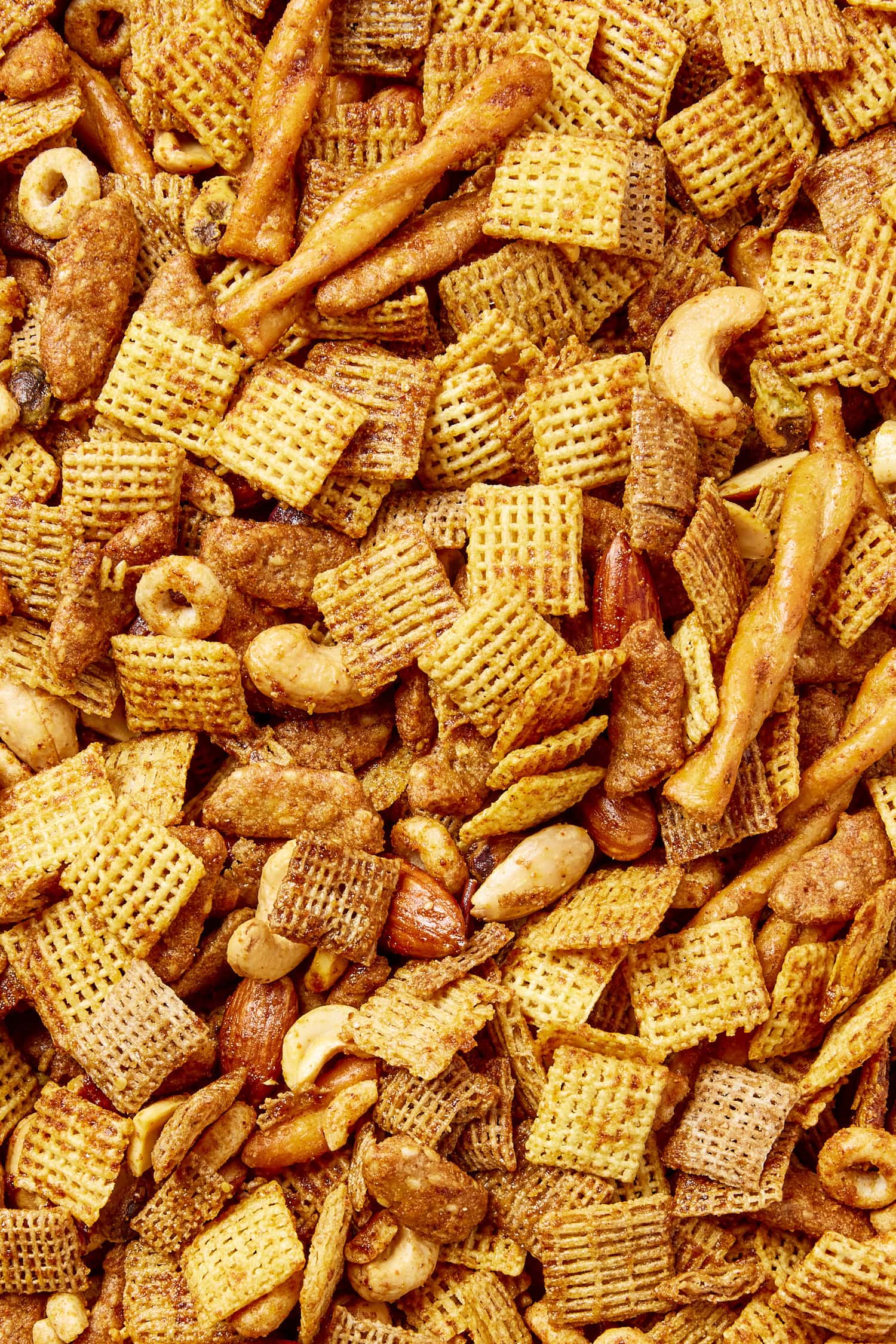 Mixture of cereal, pretzels, and nuts to form a smoky party mix.