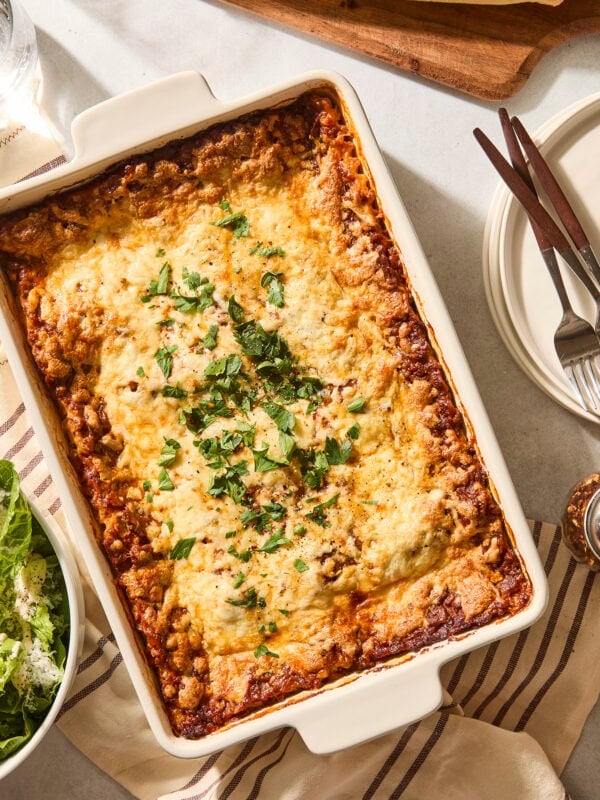 Baked casserole pan with homemade lasagna topped with parsley.