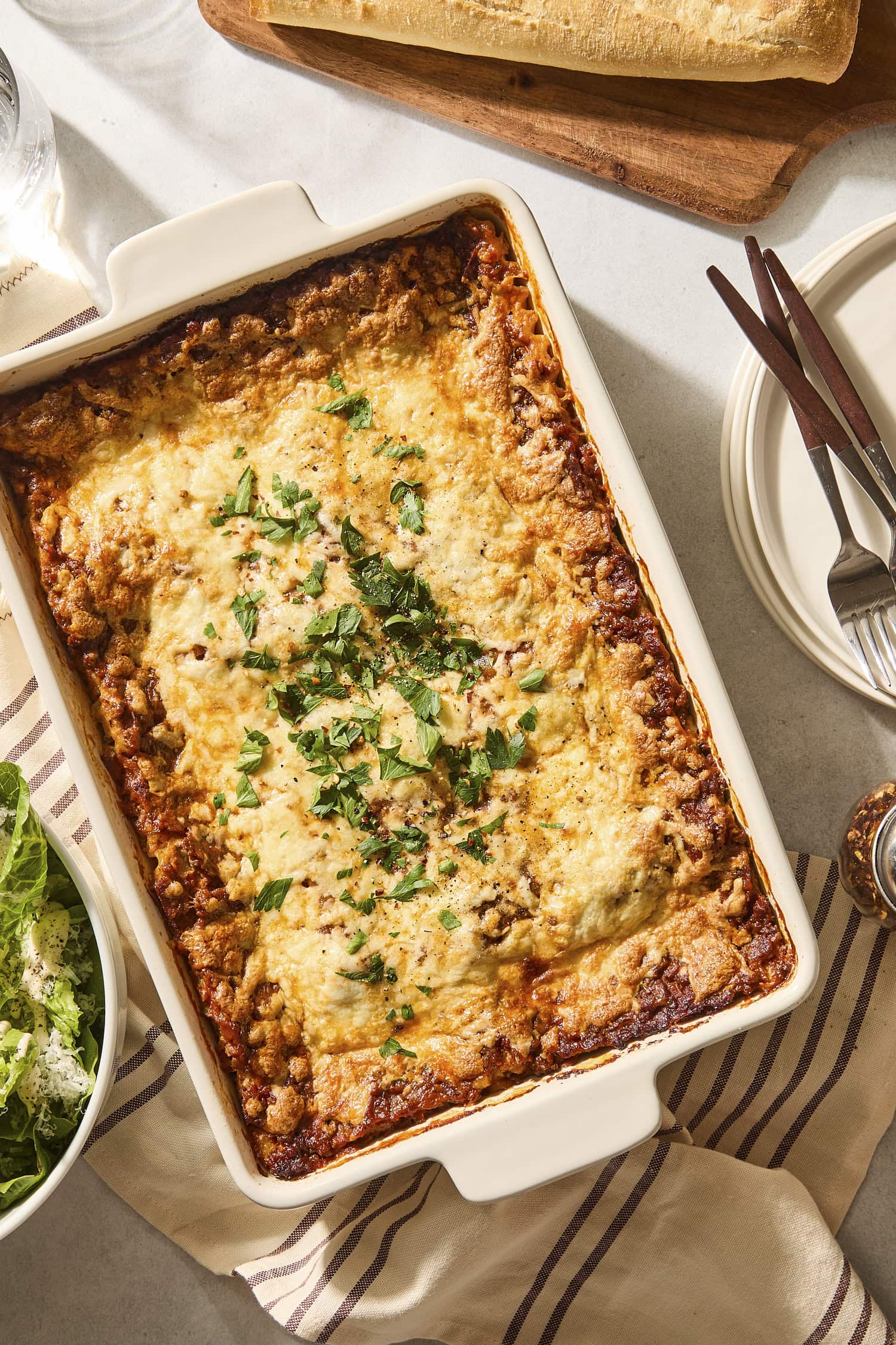 Baked casserole pan with homemade lasagna topped with parsley.