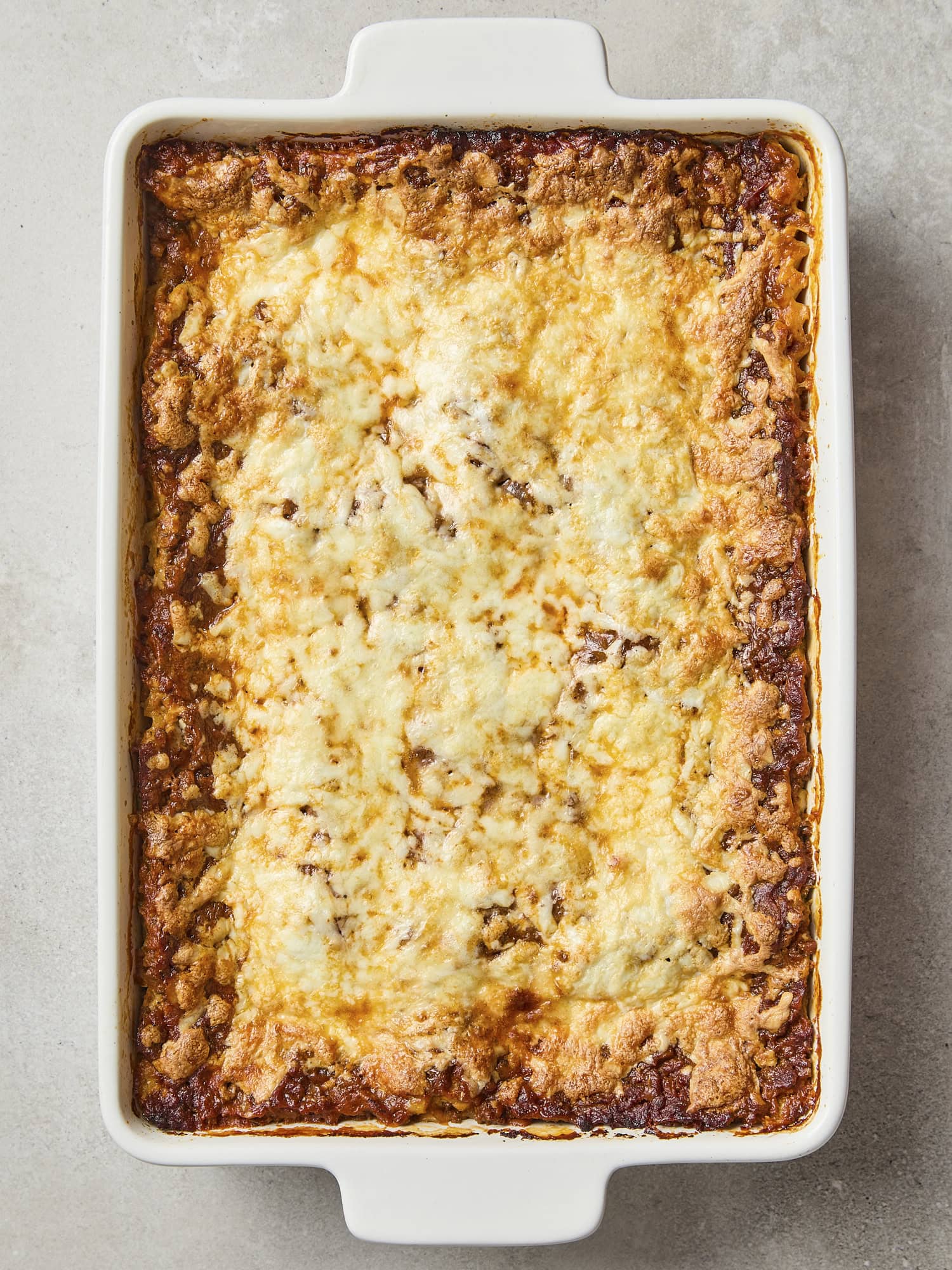 Baked homemade lasagna with melted cheese on top.
