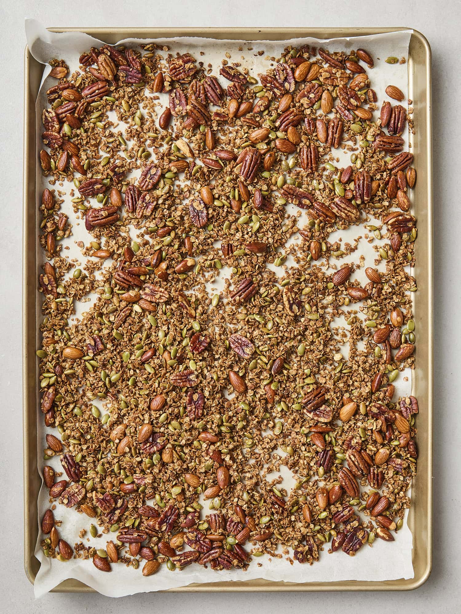 Toasted homemade granola on a baking sheet.
