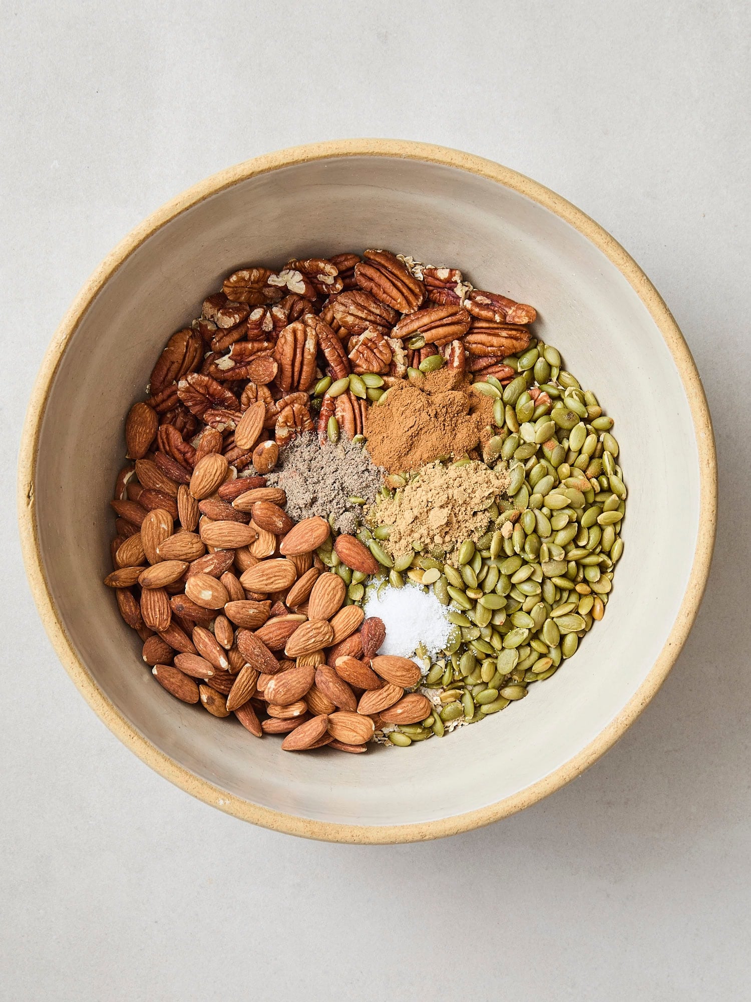 Bowl filled with ingredients needed for homemade granola.