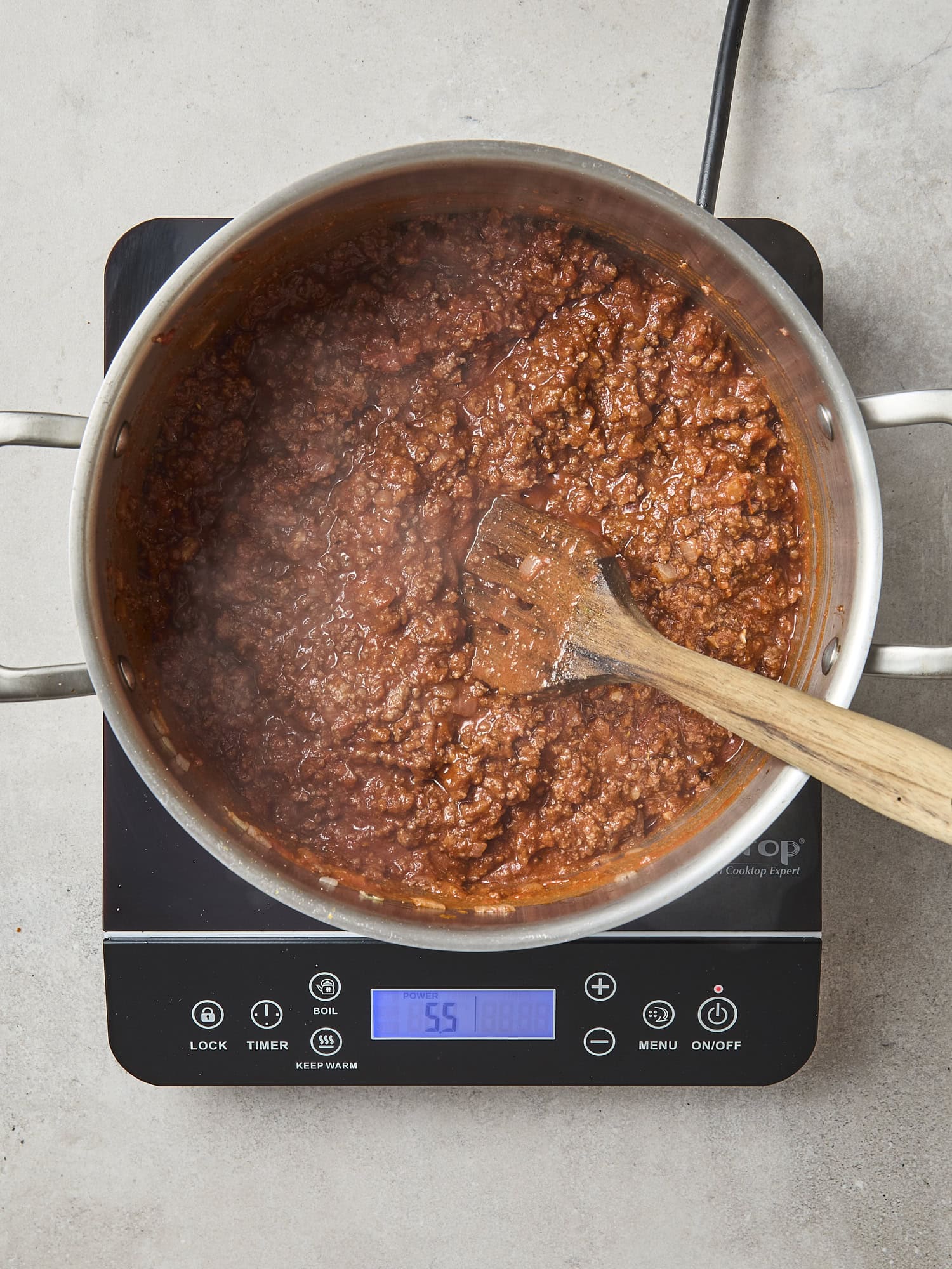 Meat sauce cooking in a pan for lasagna.