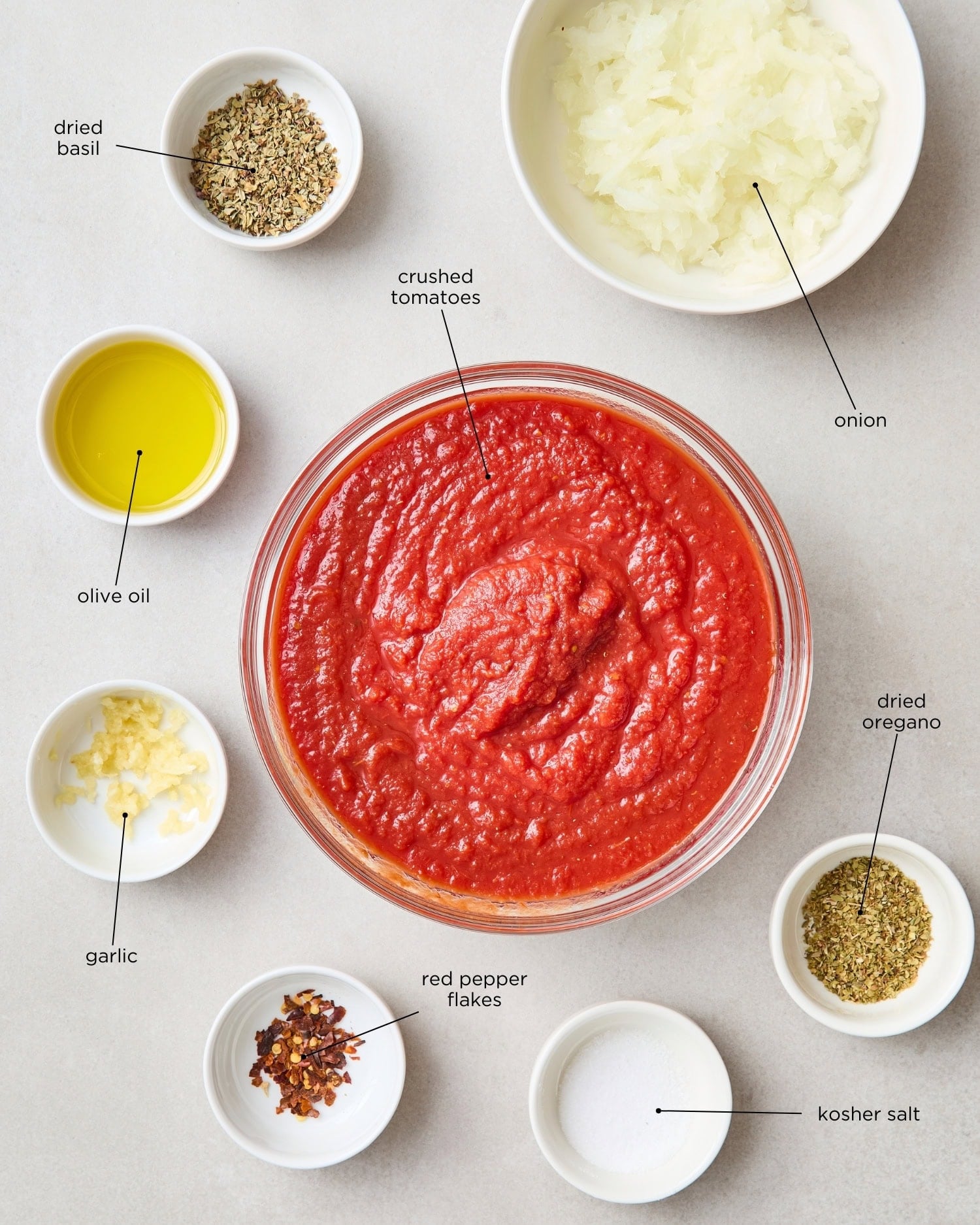 Concrete surface with ingredients needed for easy homemade marinara sauce.