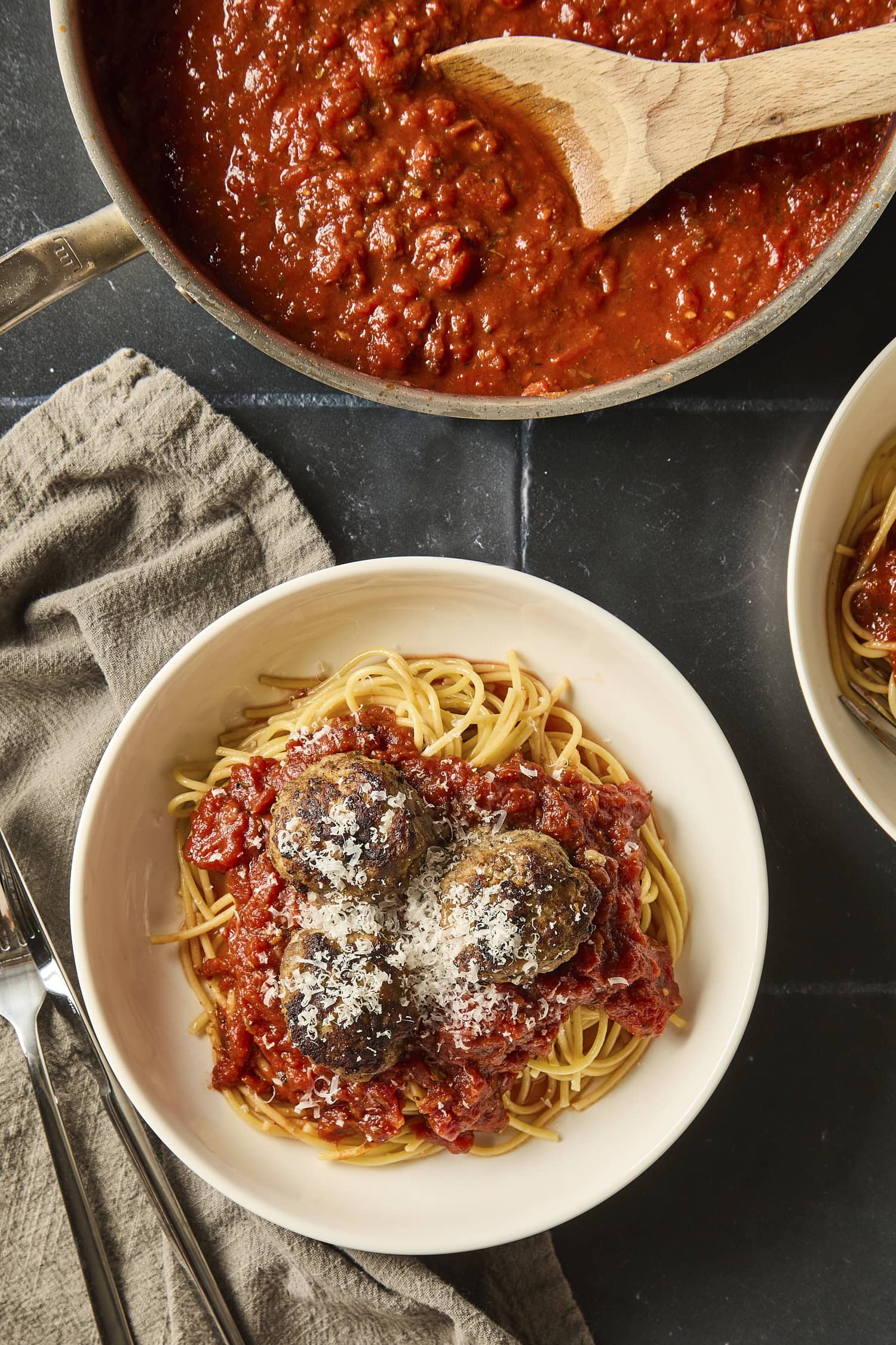 A small plate with spaghetti, red sauce, and meatballs.