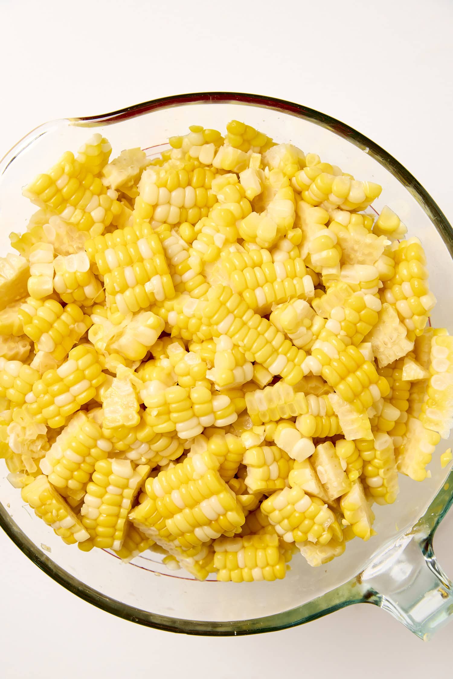 Measuring cup filled with sweet corn kernels before freezing.