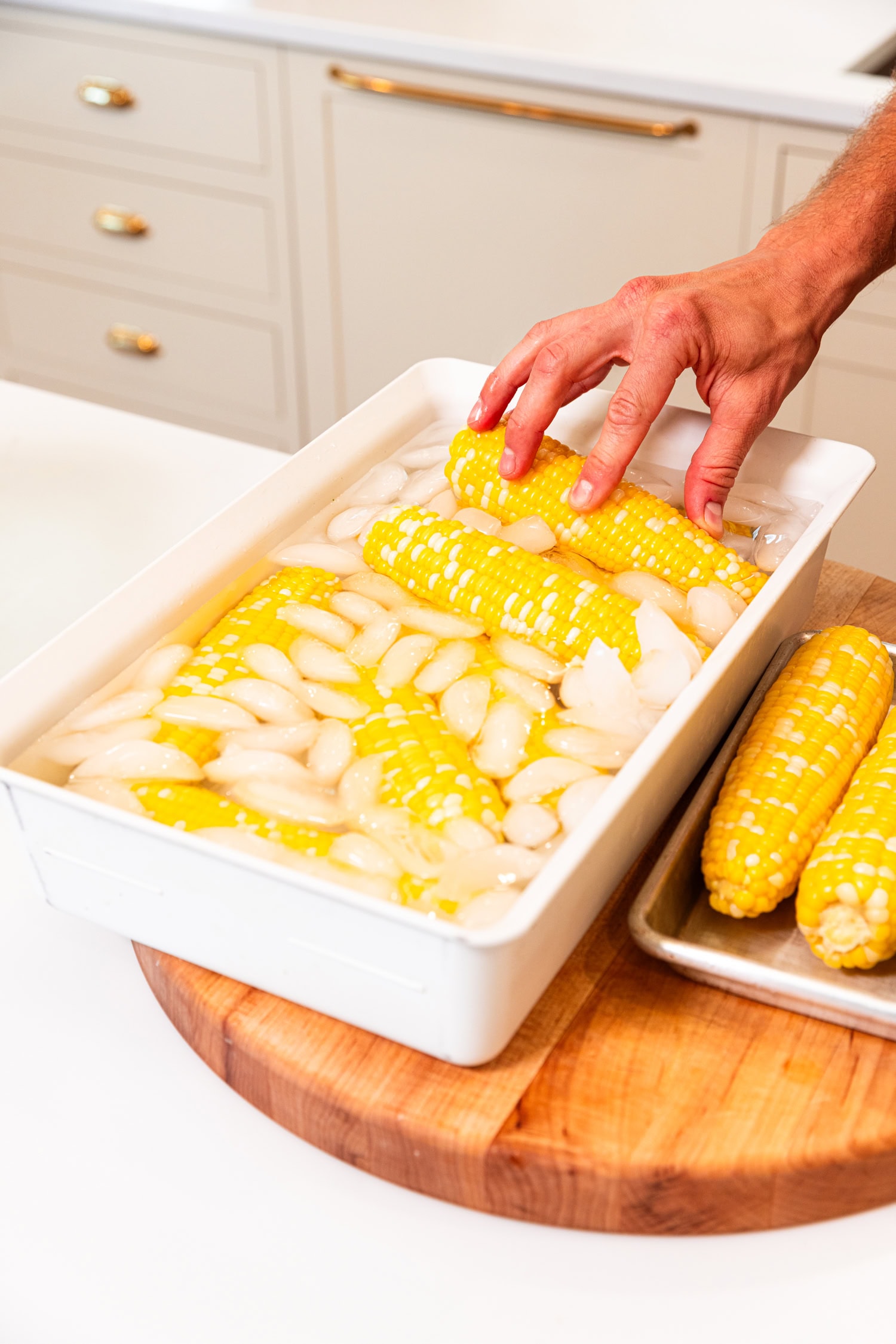 Ears of corn in ice water bath.
