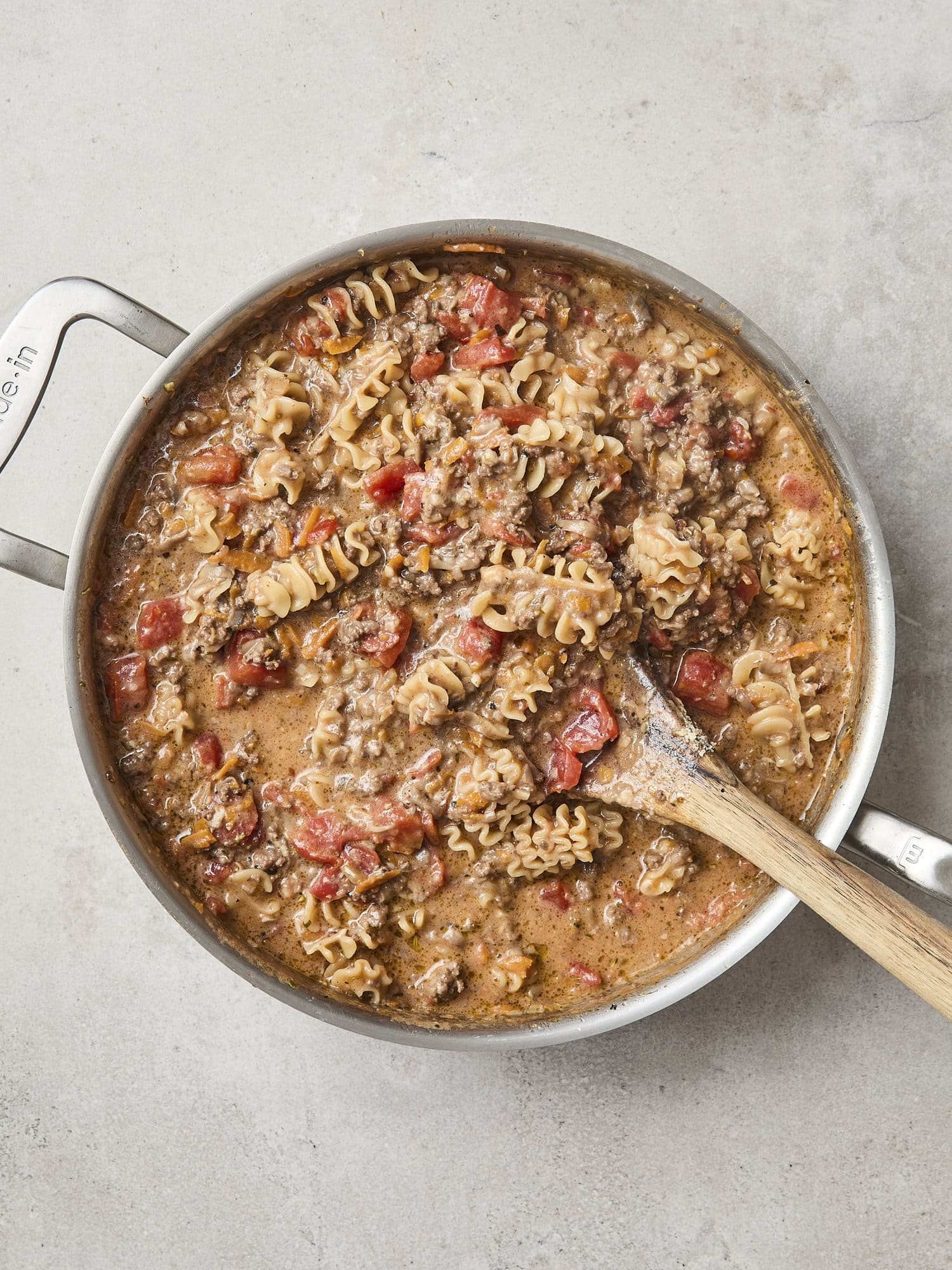 Skillet with finished beef ragu pasta.