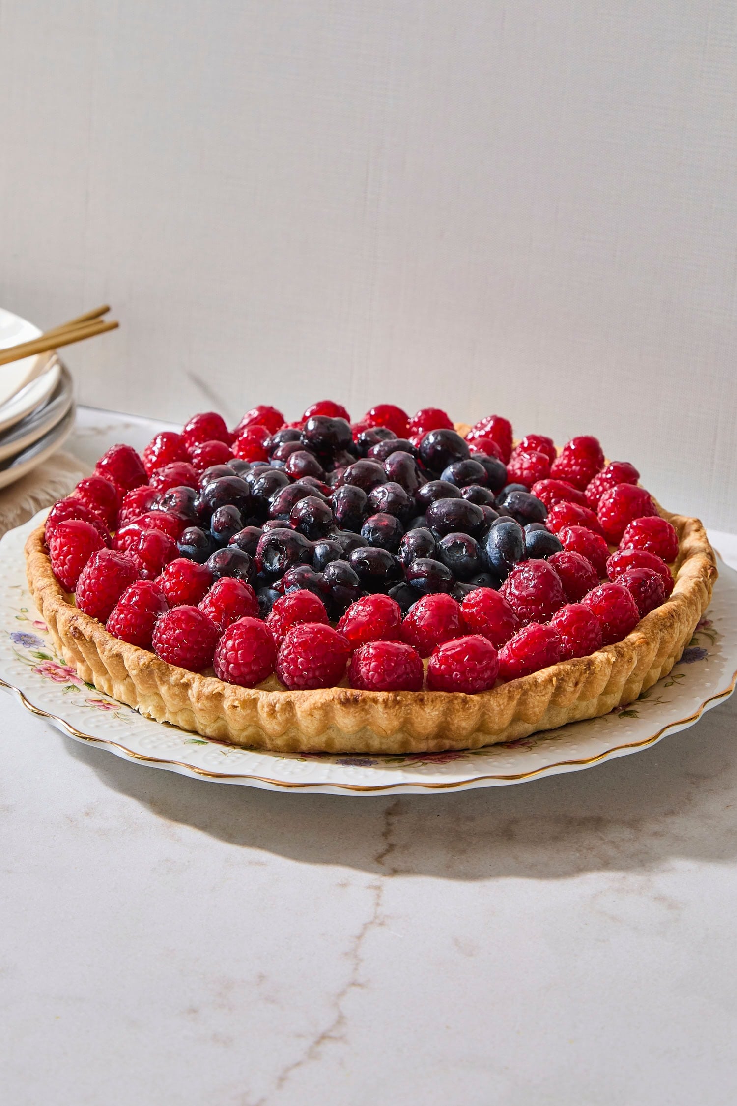 Fruit tart with blueberries and raspberries on top.