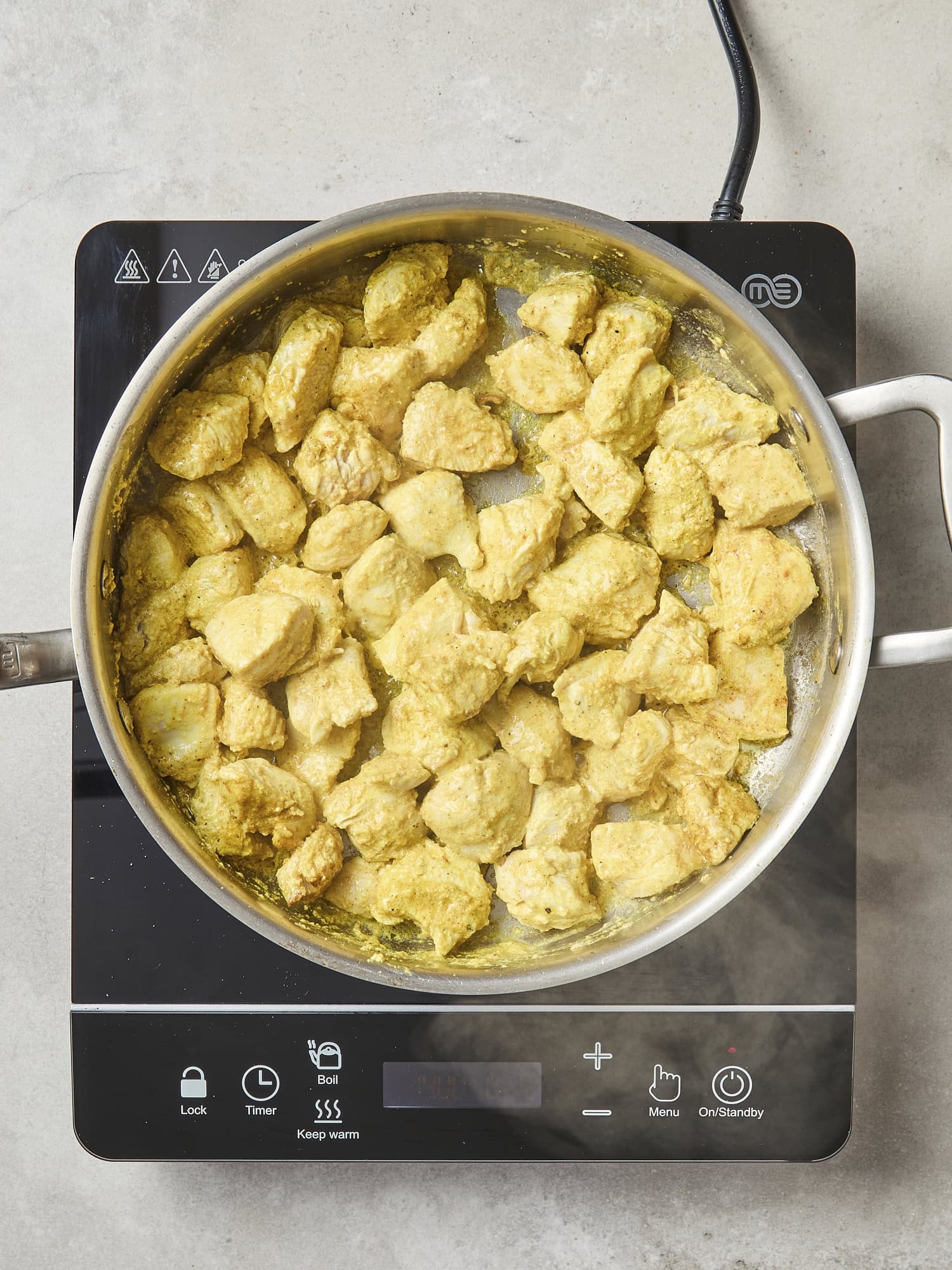 Cooked chicken in a pan before adding sauce.