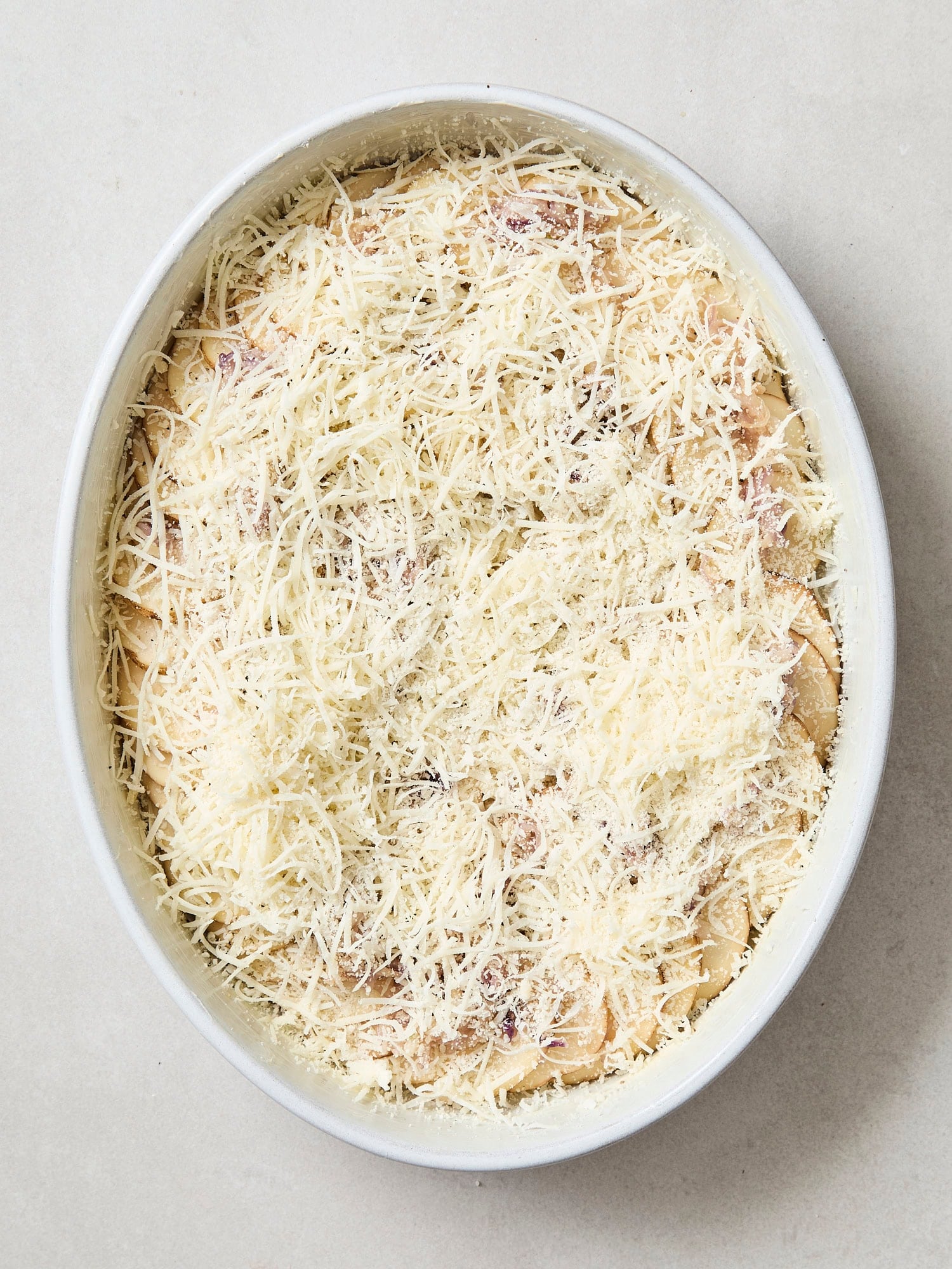 Cheese on top of layered potatoes.