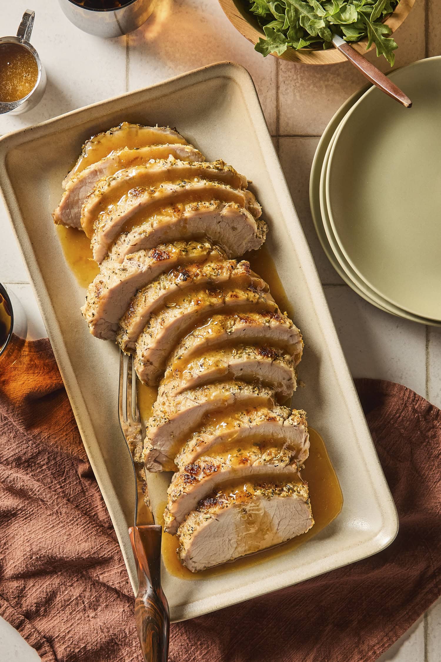Platter with slices of pork roast with citrus glazed on top.