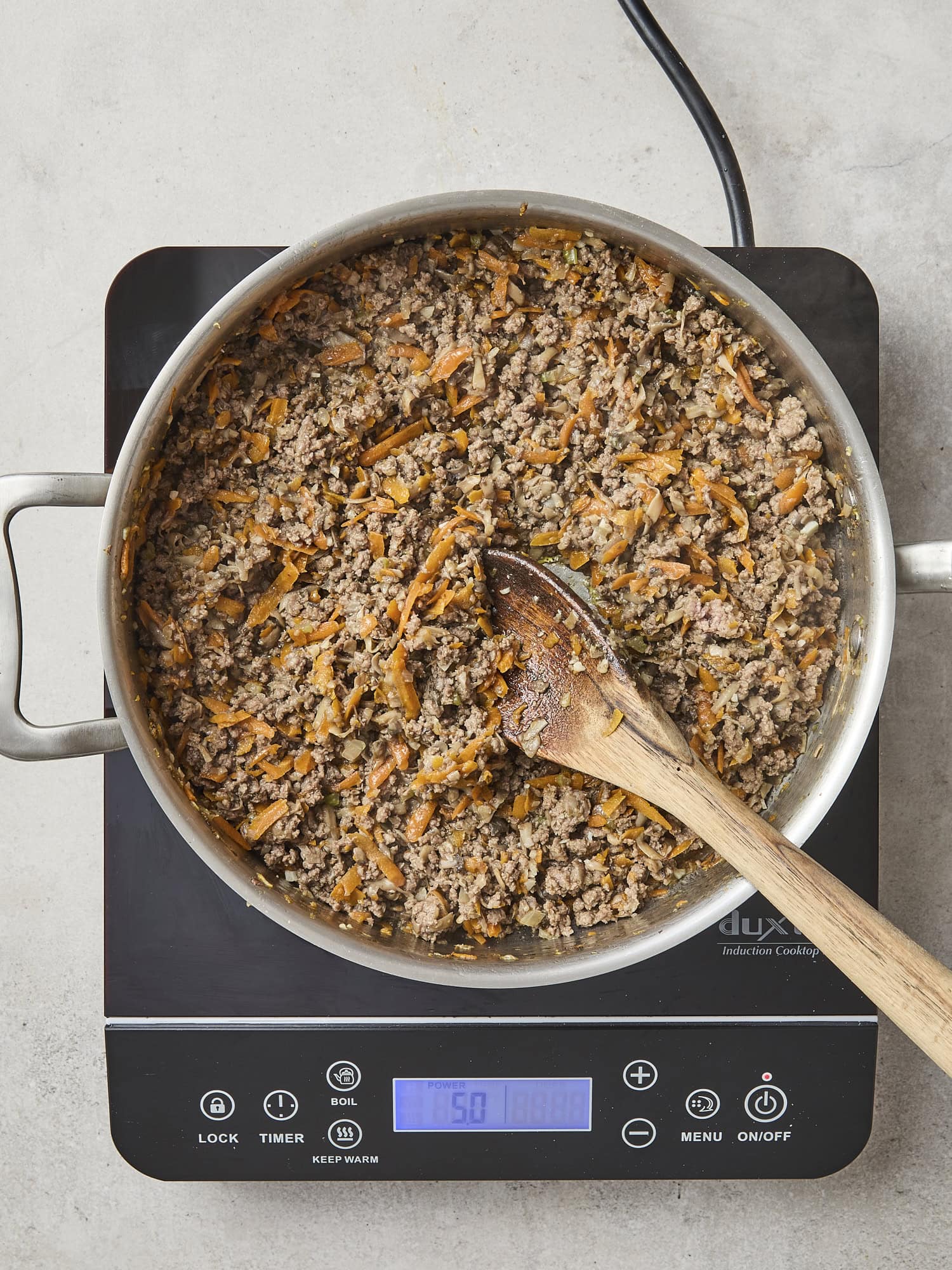 Ground beef cooked in skillet.