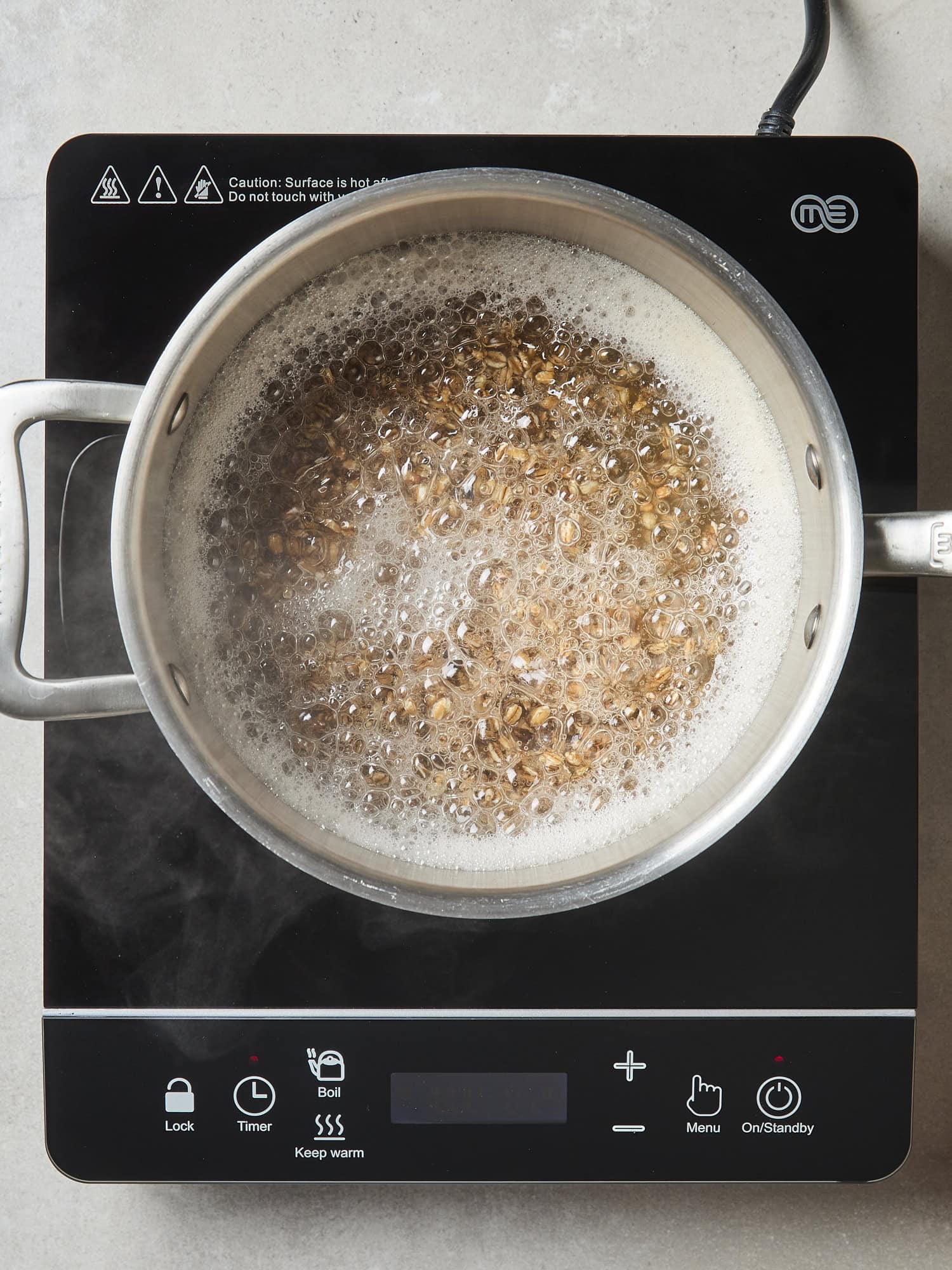 Cooking farro in saucepan.