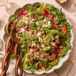 Platter with greens and topped with farro, blood orange segments, pomegranates, feta, and more.