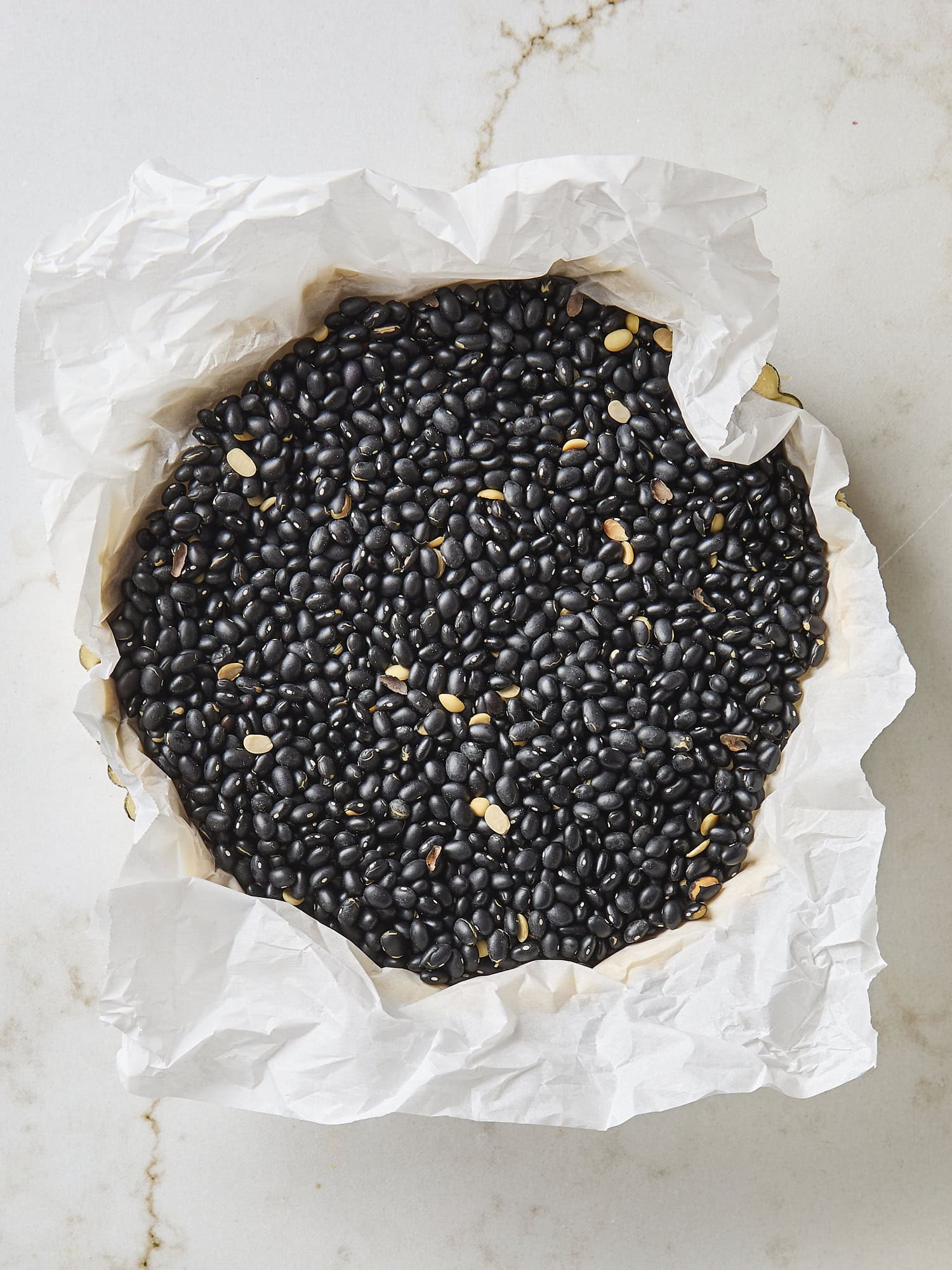Baking beans in a tart shell for prebaking.
