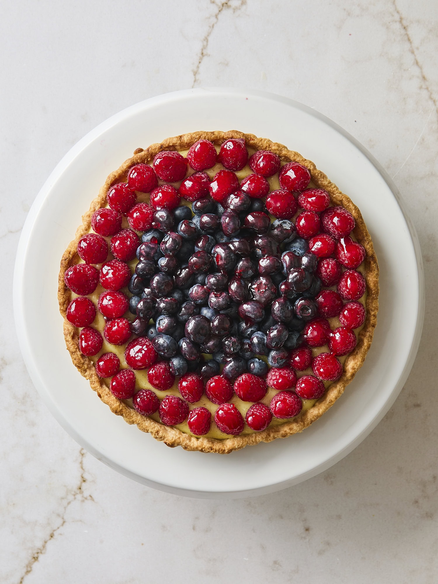 Glazed fresh fruit tart with pastry cream underneath.