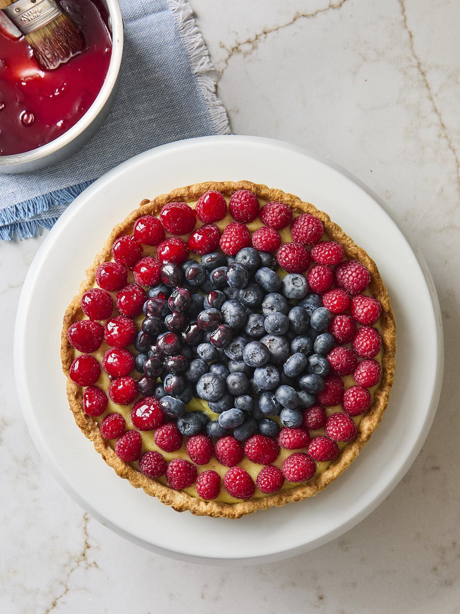 Glazing the top of a fresh fruit tart.