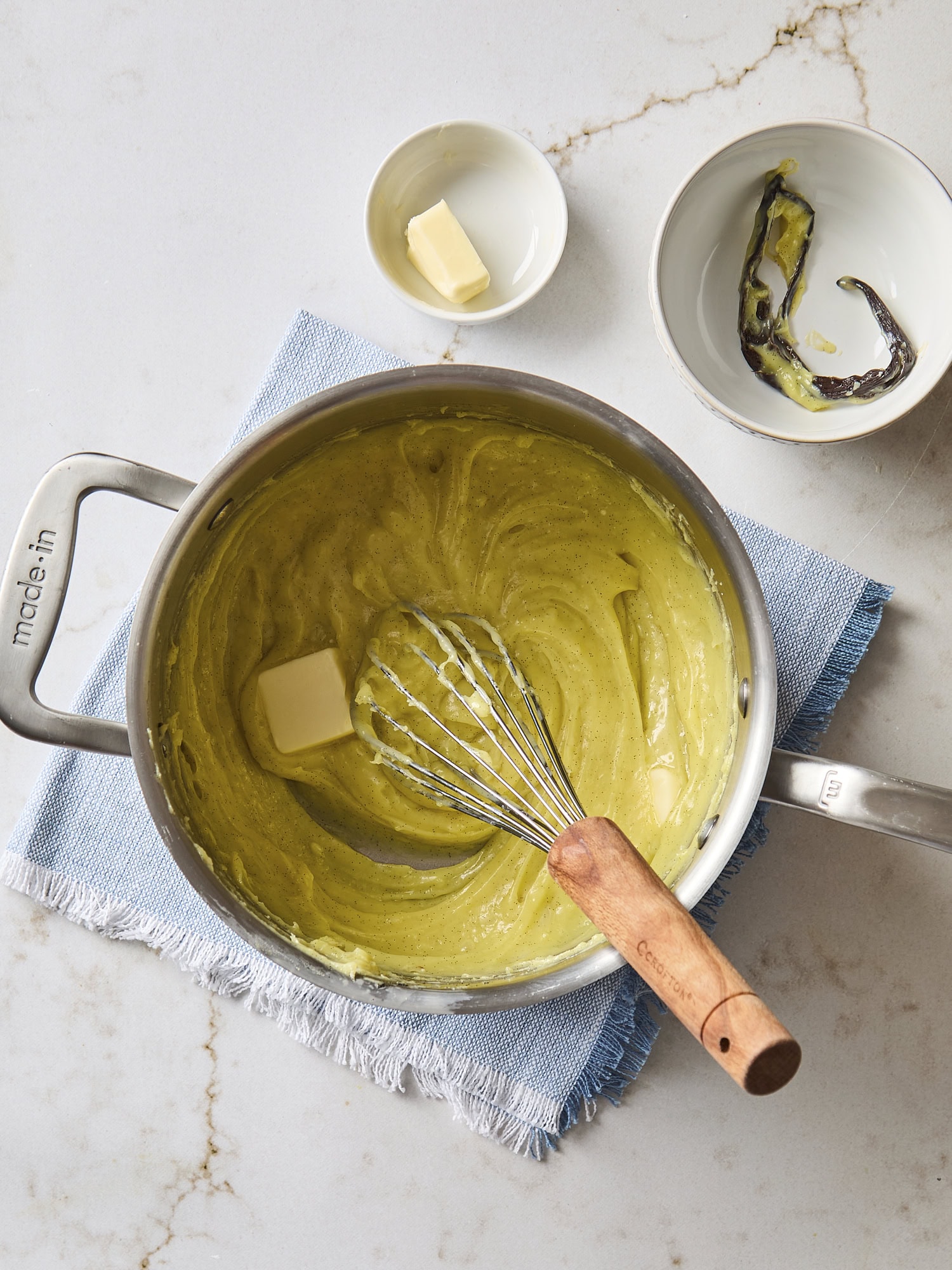 Cooked pastry cream with butter being added.