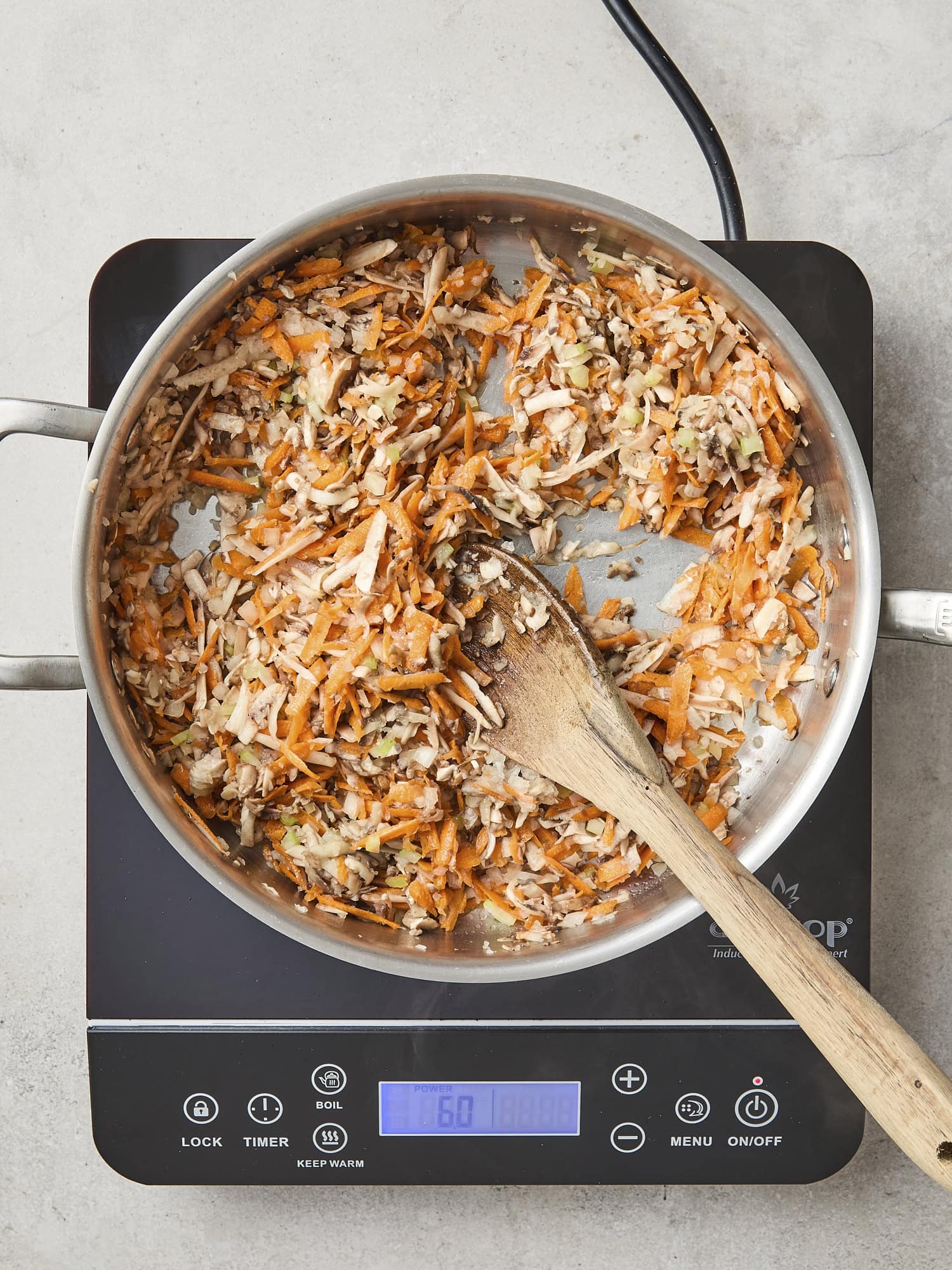Raw vegetables cooking in skillet.