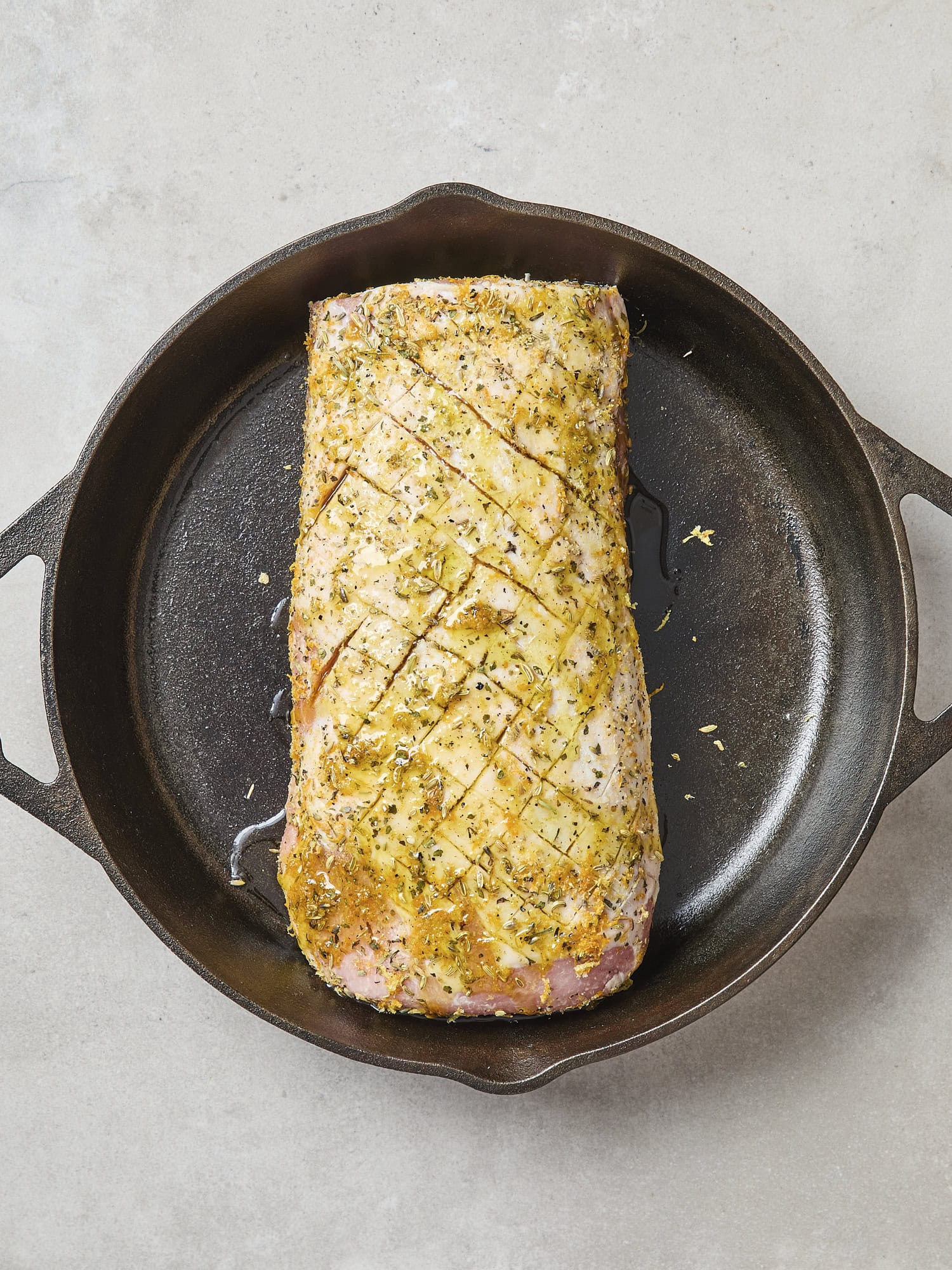 Pork roast with rub in skillet.