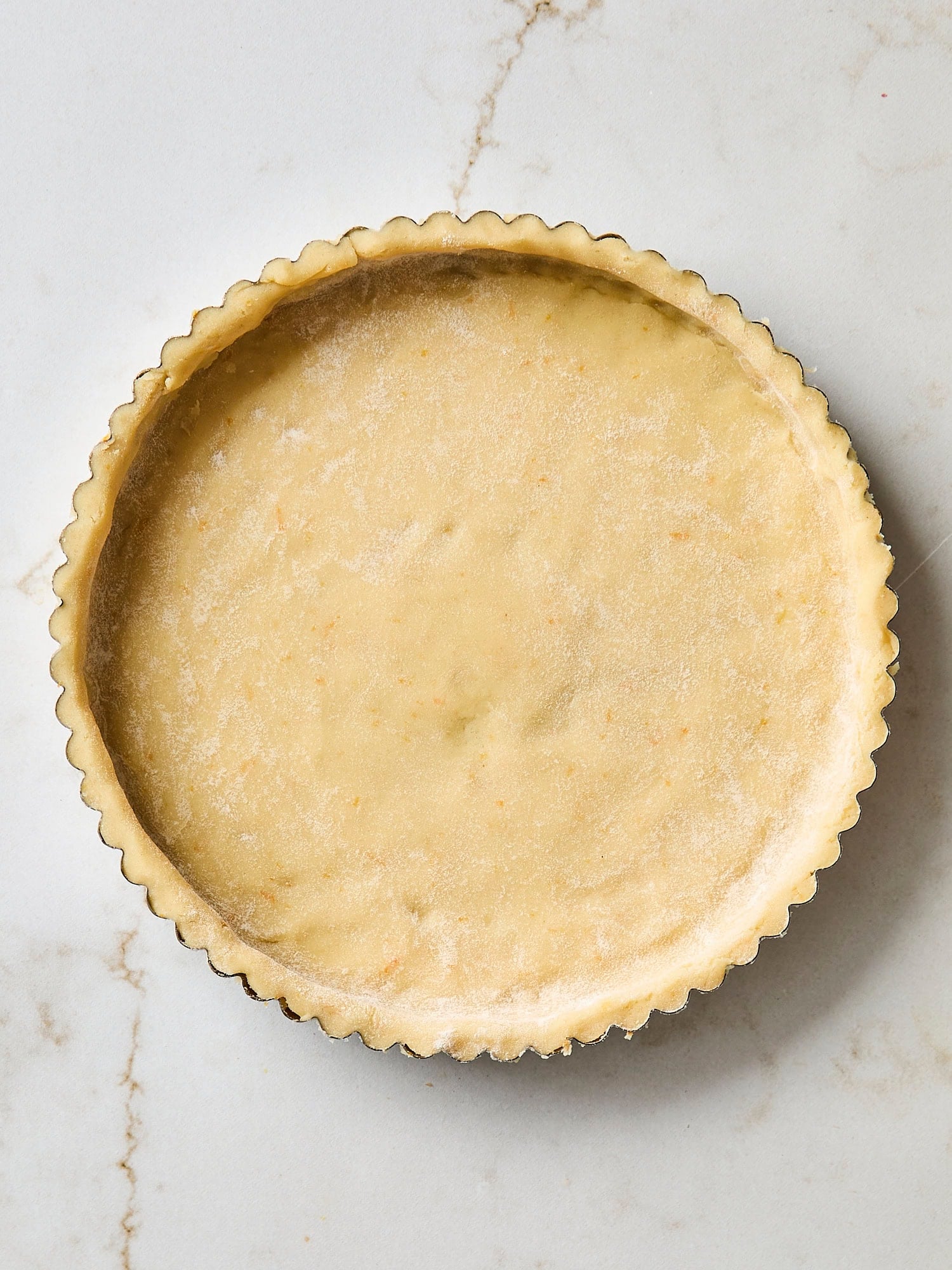 Pie dough fitted into a tart shell.