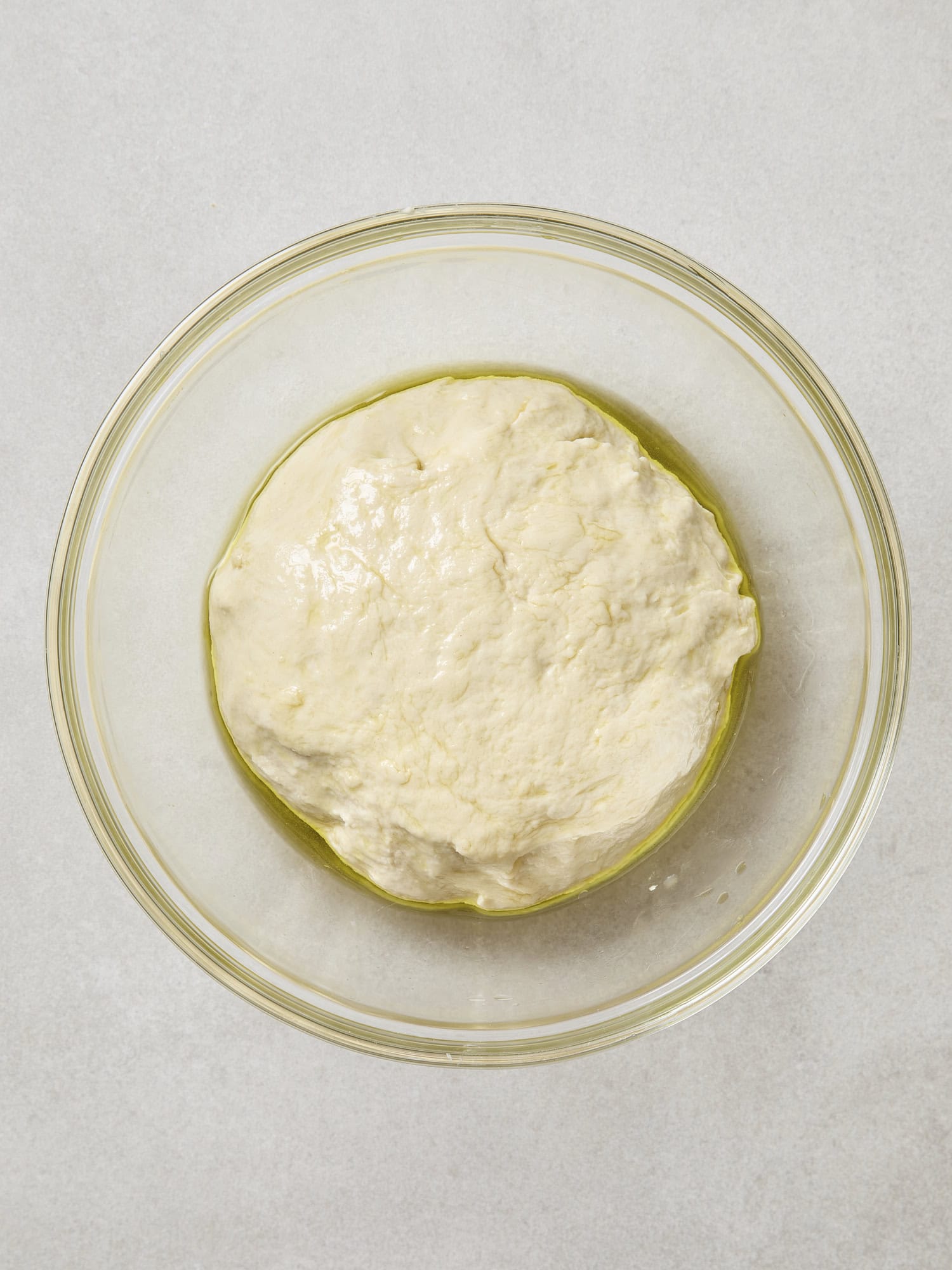 Dough in bowl with olive oil before rising.