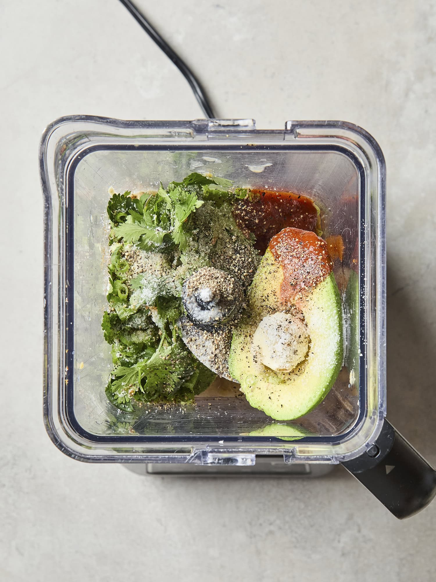 Blender with ingredients needed for avocado hummus.