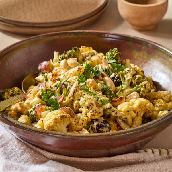 Curry, broccoli, and cauliflower salad in a serving bowl.