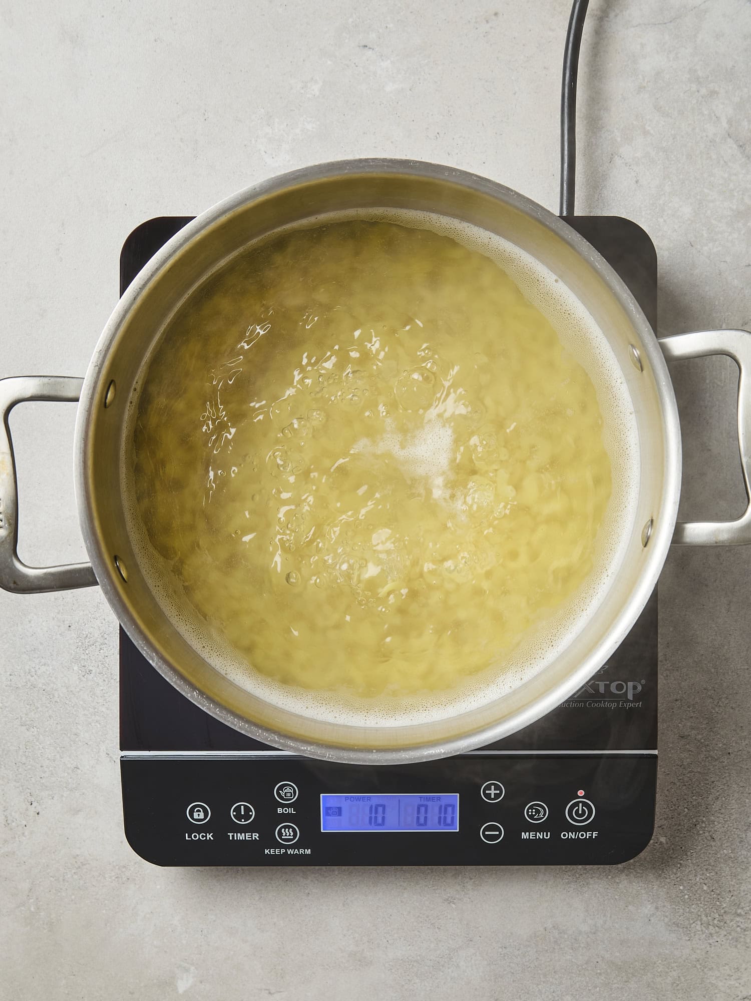 Pasta cooking in water for macaroni salad.