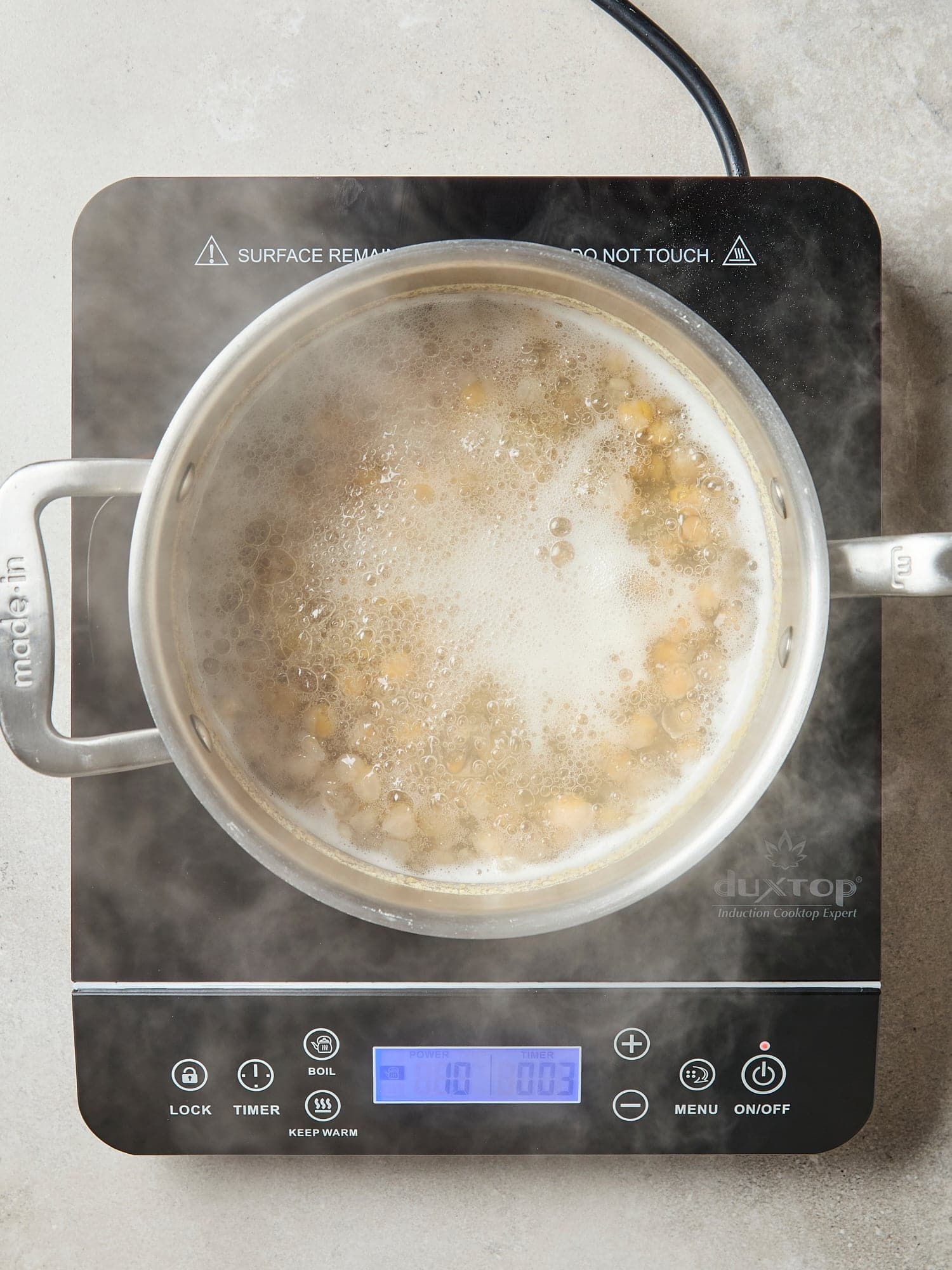 Chickpeas cooking in liquid.
