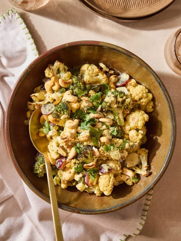 Curry, broccoli, and cauliflower salad topped with cilantro and cashews.