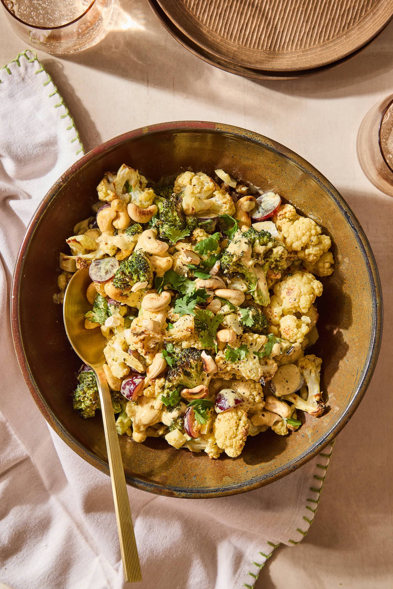 Curry, broccoli, and cauliflower salad topped with cilantro and cashews.