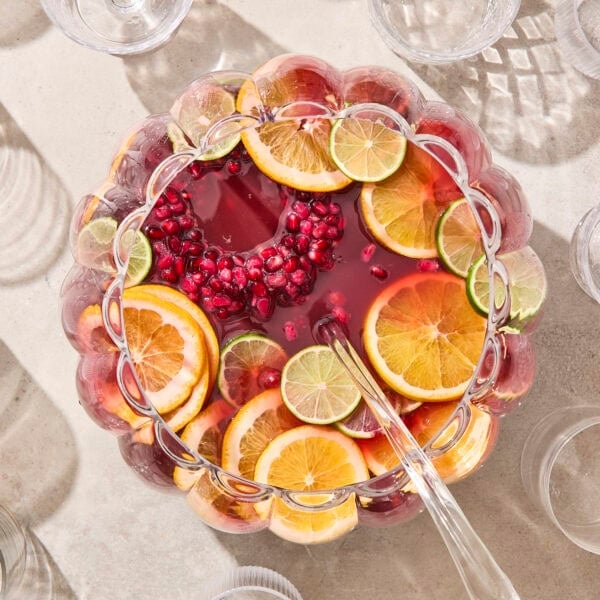 Punch bowl with pomegranate punch and citrus and ice ring.