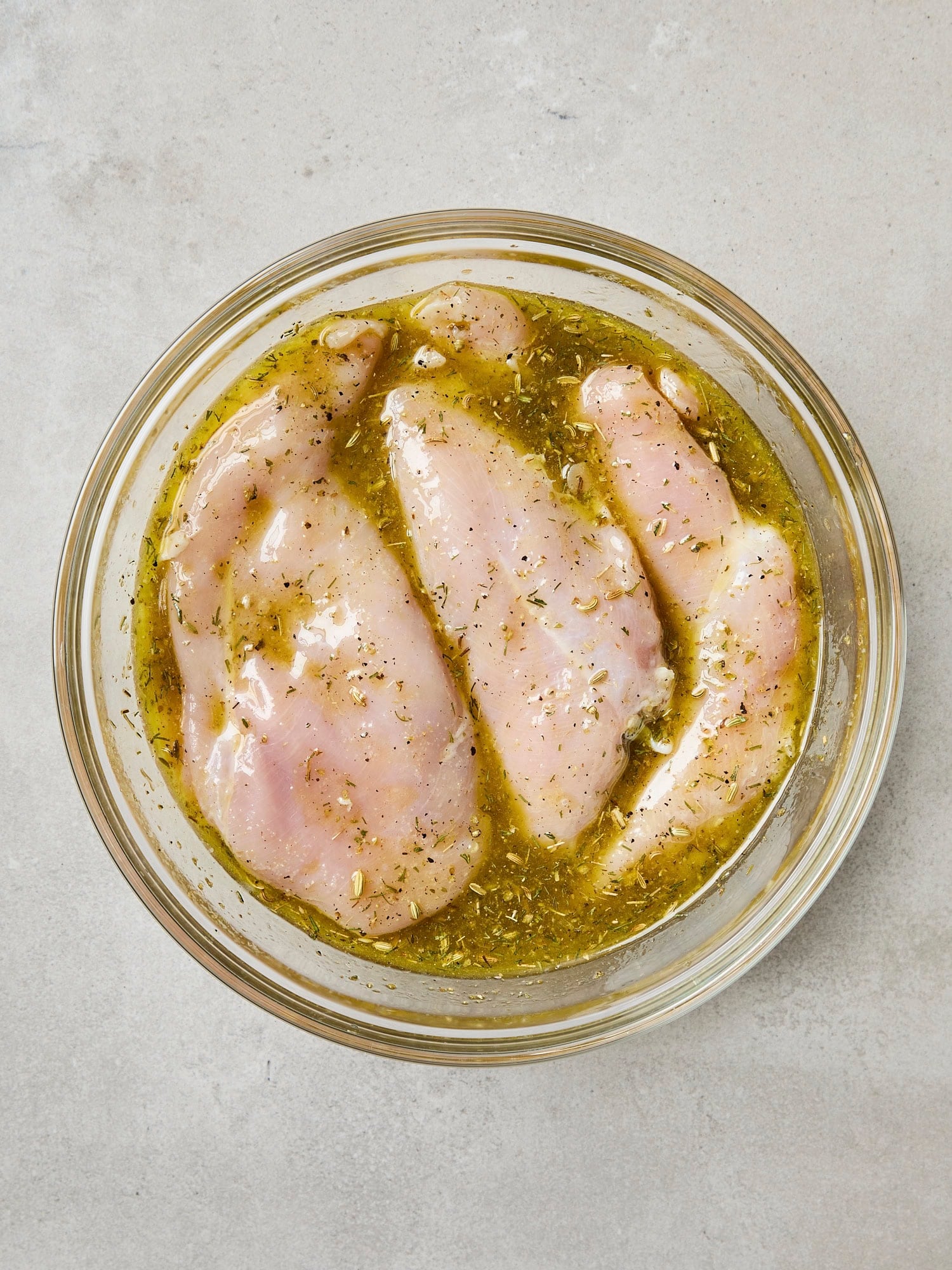 Raw chicken breast submerged in mariade.