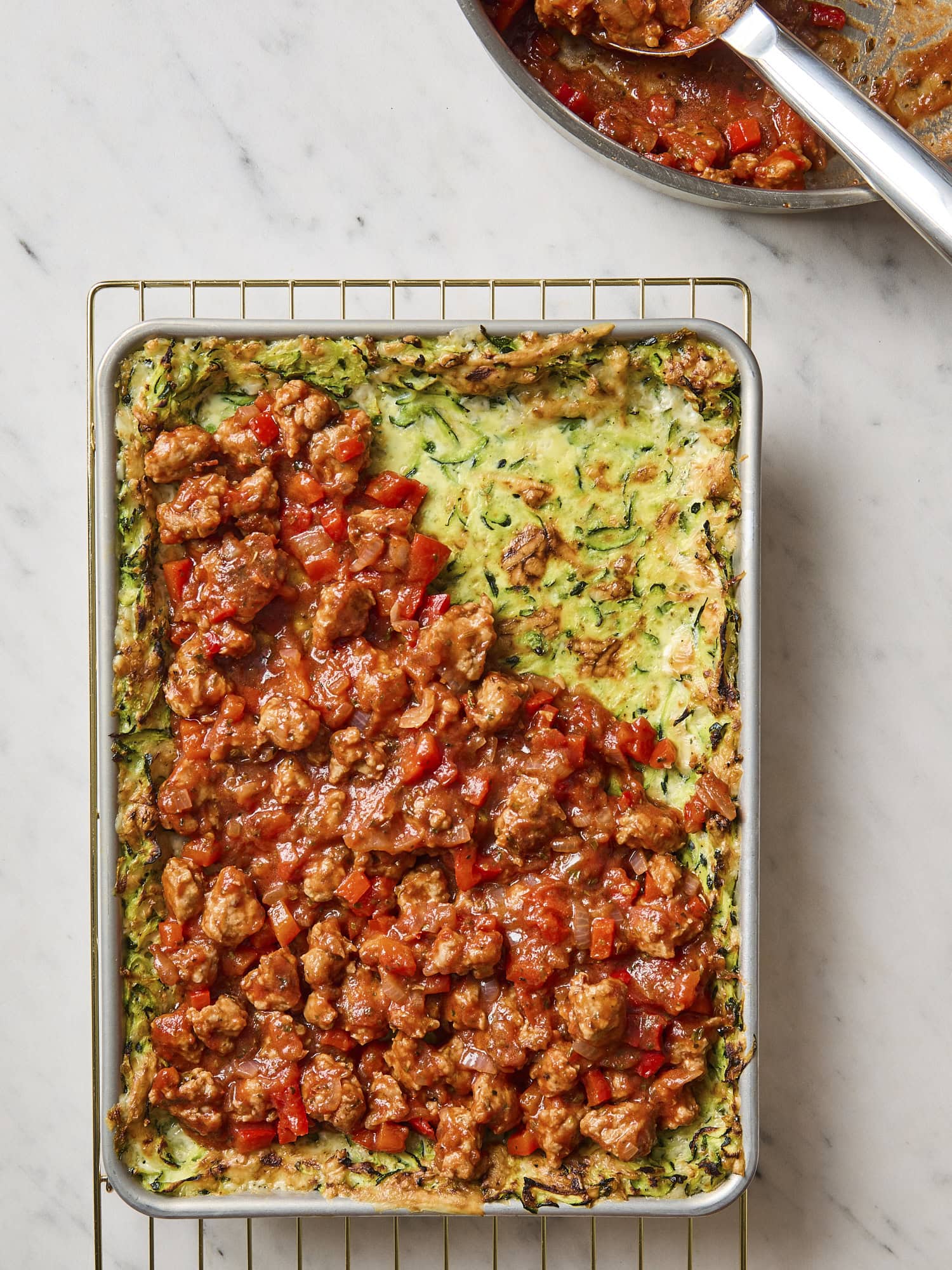 Baked zucchini crust with pizza sauce on top.