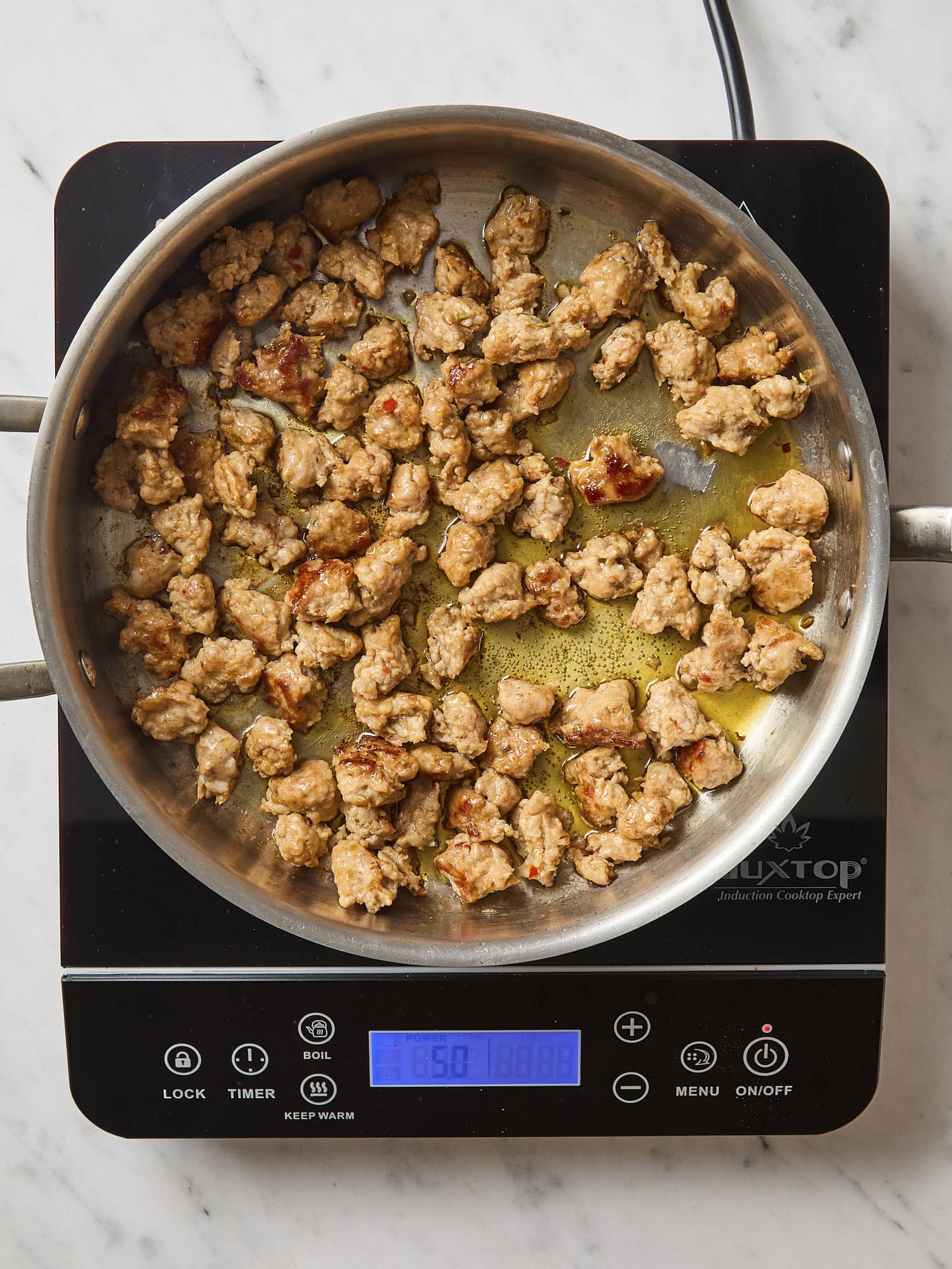 Cooked sausage in skillet.