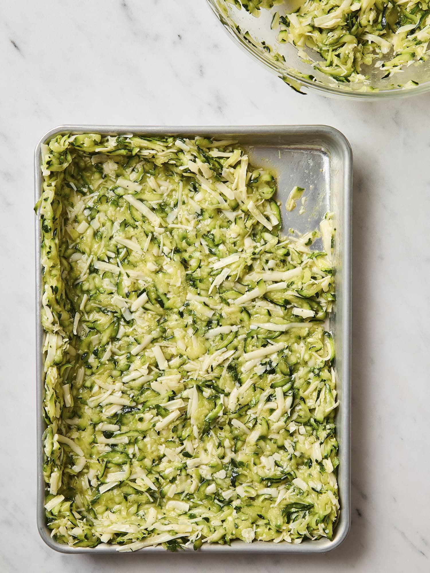 Zucchini mixture being pressed into crust.