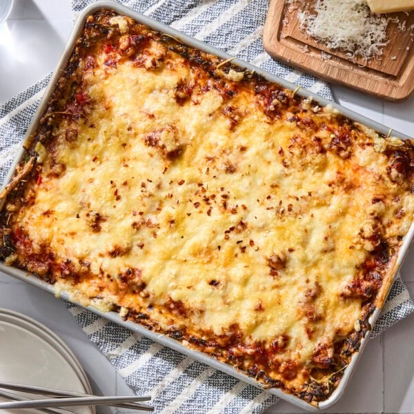 Sheet pan with baked zucchini pizza recipe.