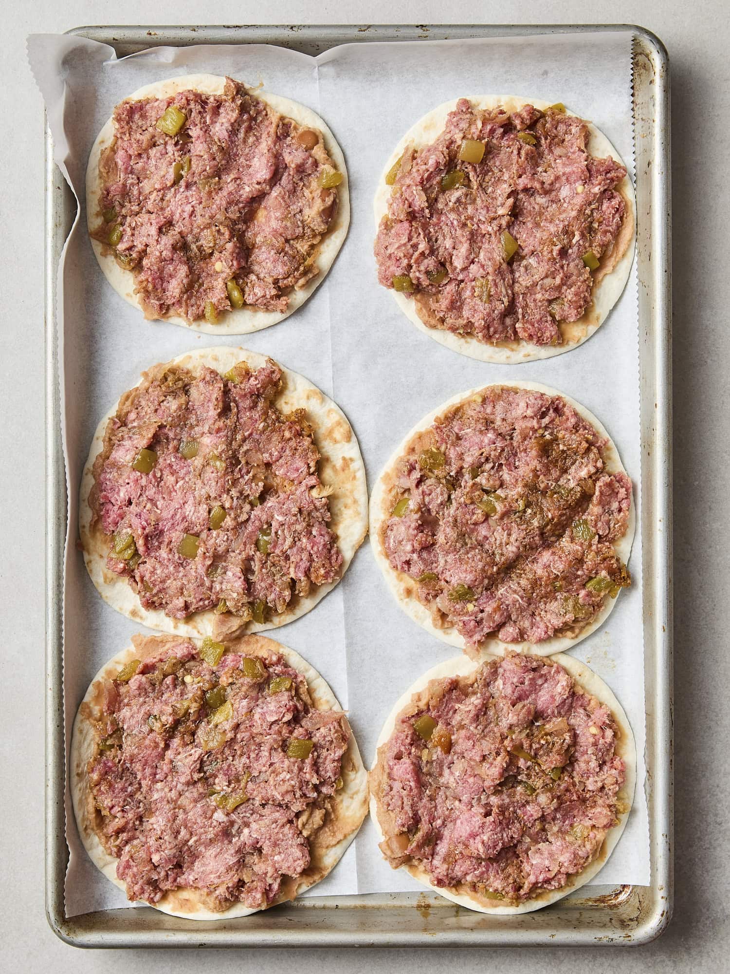 Beef mixture spread on tortillas for beef tacos.