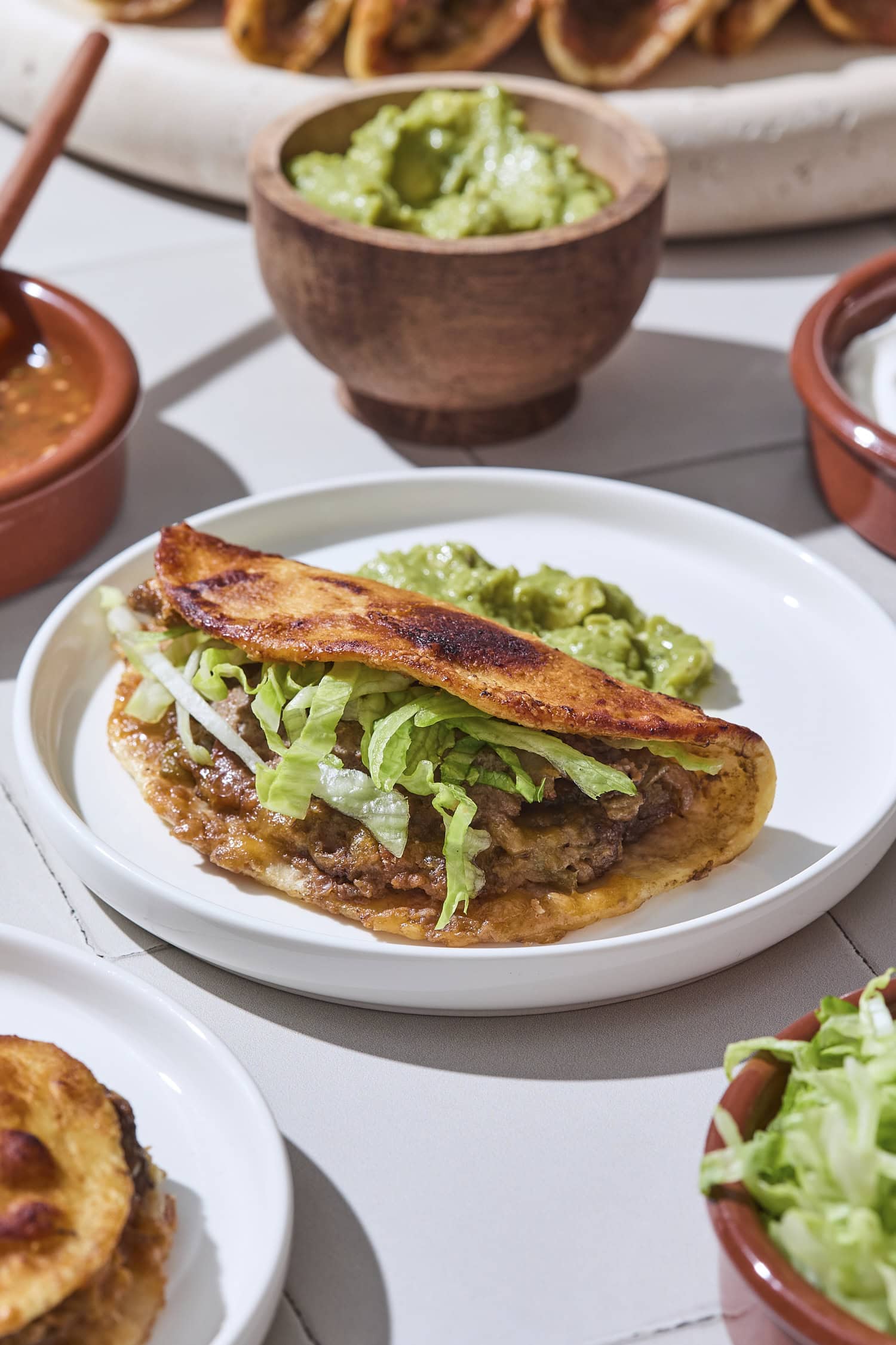 Plate with a baked beef taco with crispy exterior.